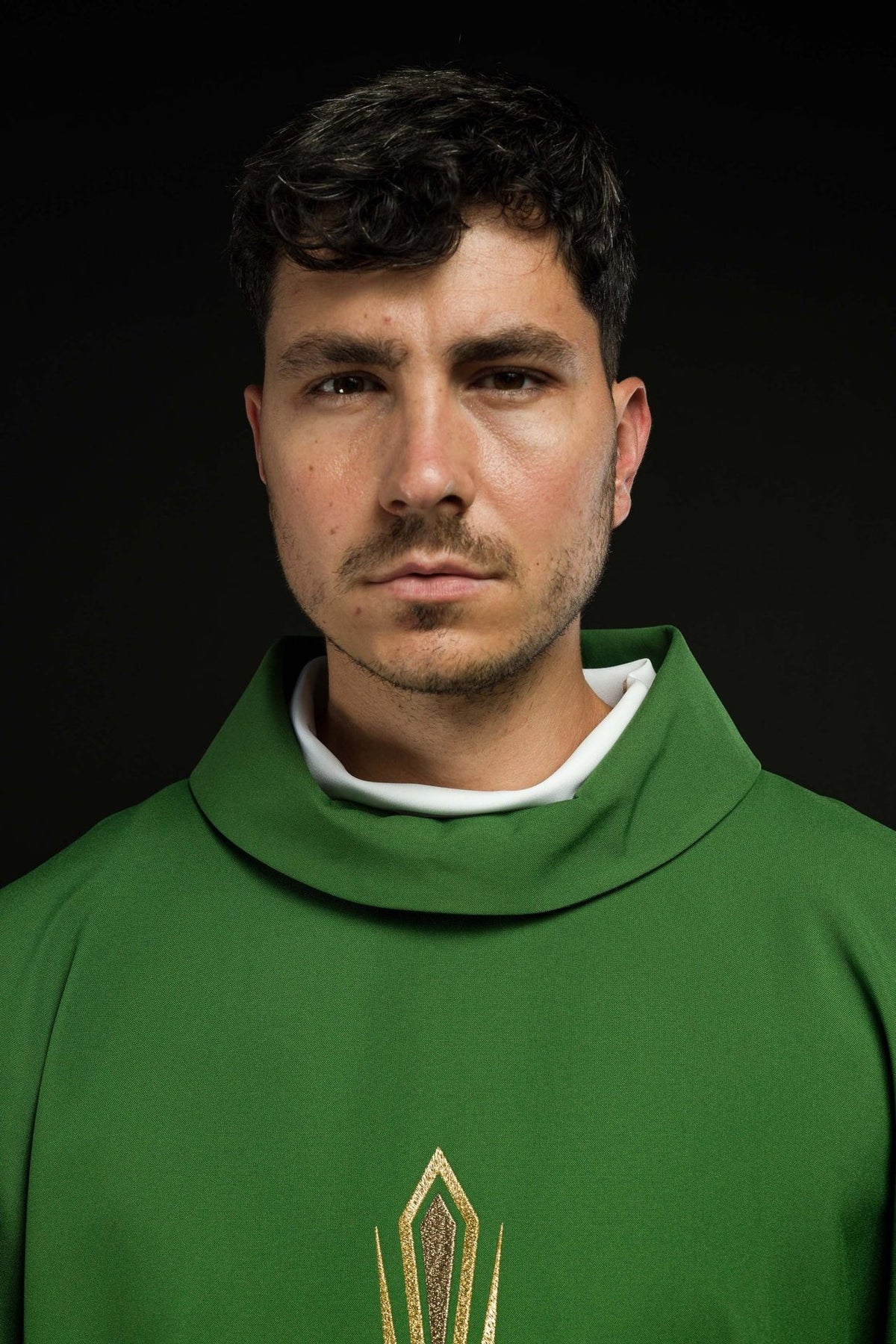 Green chasuble close-up showing stand-up collar and upper cross embroidery