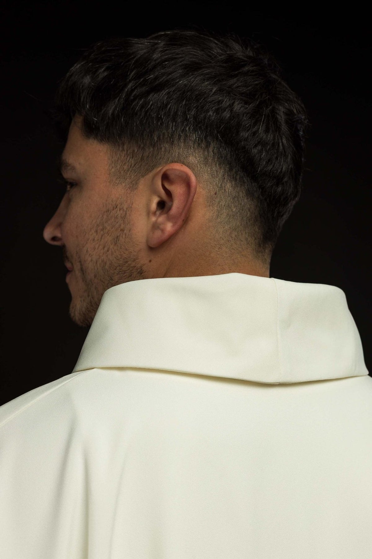 Ivory chasuble side-back close-up showing its stand-up collar