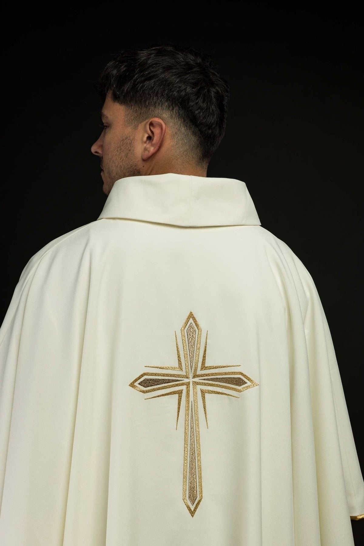 Chasuble back view showing ivory fabric, stand-up collar and gold cross embroidery