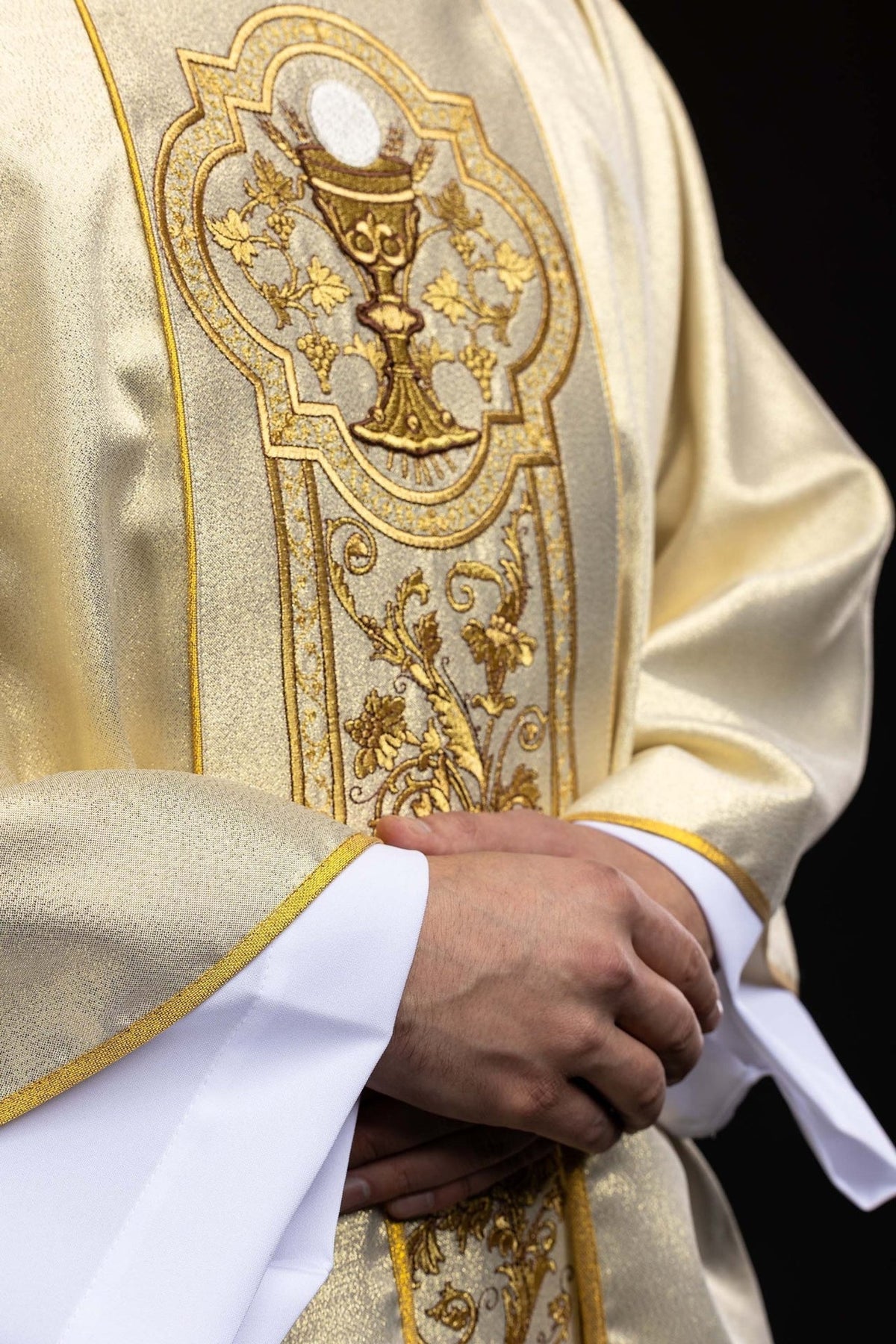 Gold chasuble close-up of chalice embroidery and floral orphrey