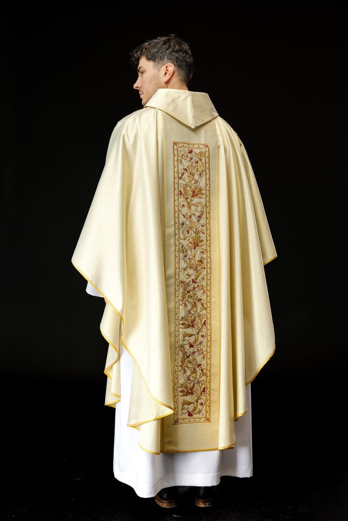 Gold chasuble back view with long embroidered floral orphrey and gold trim