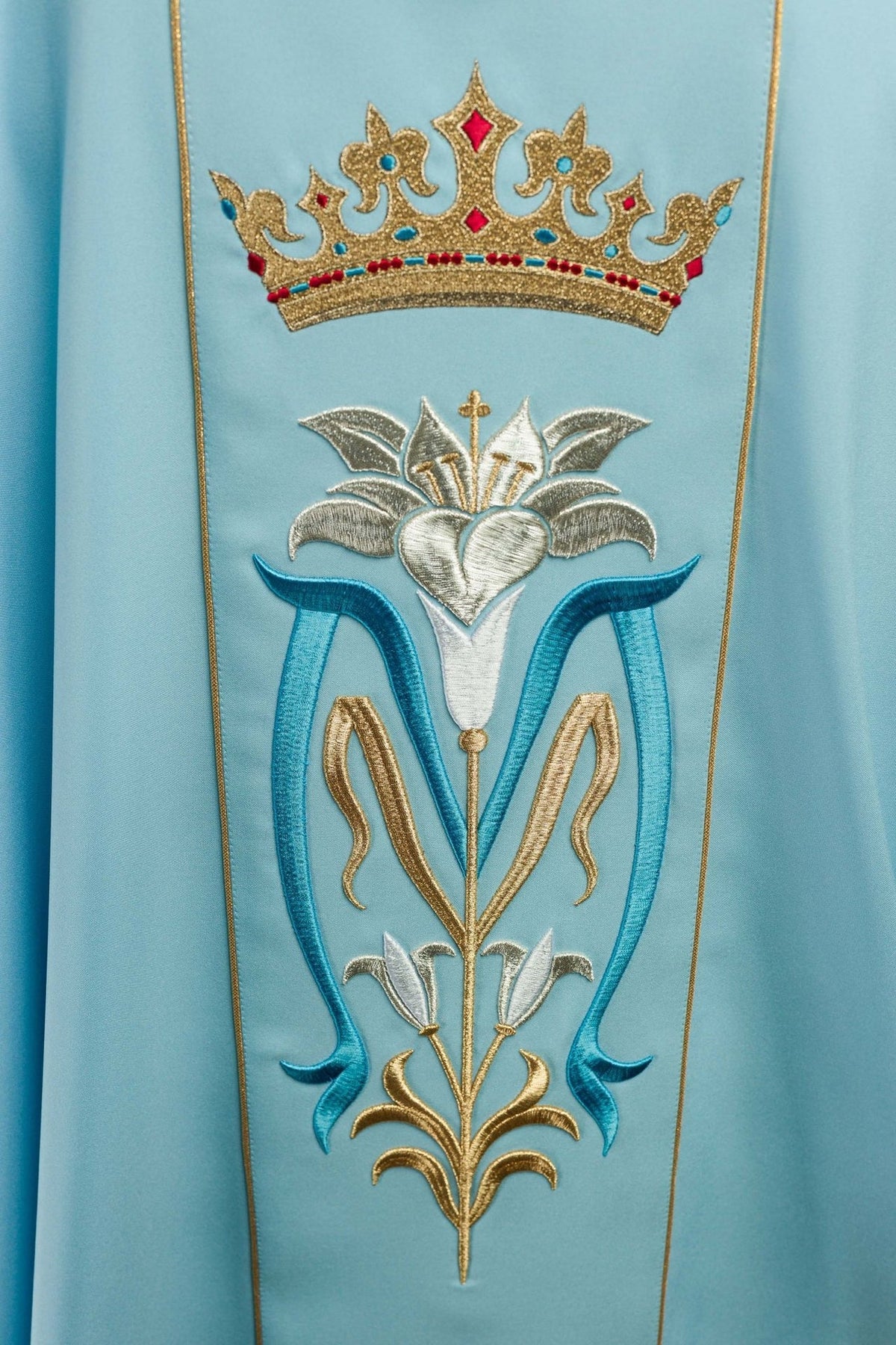Blue Marian chasuble, close-up of crown and embroidered Marian monogram