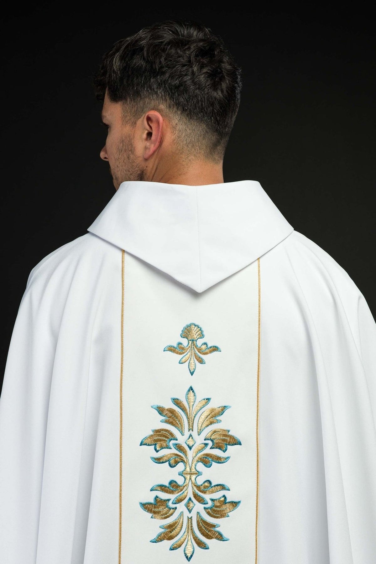 White Marian chasuble, back view with gold trim and repeated floral embroidery