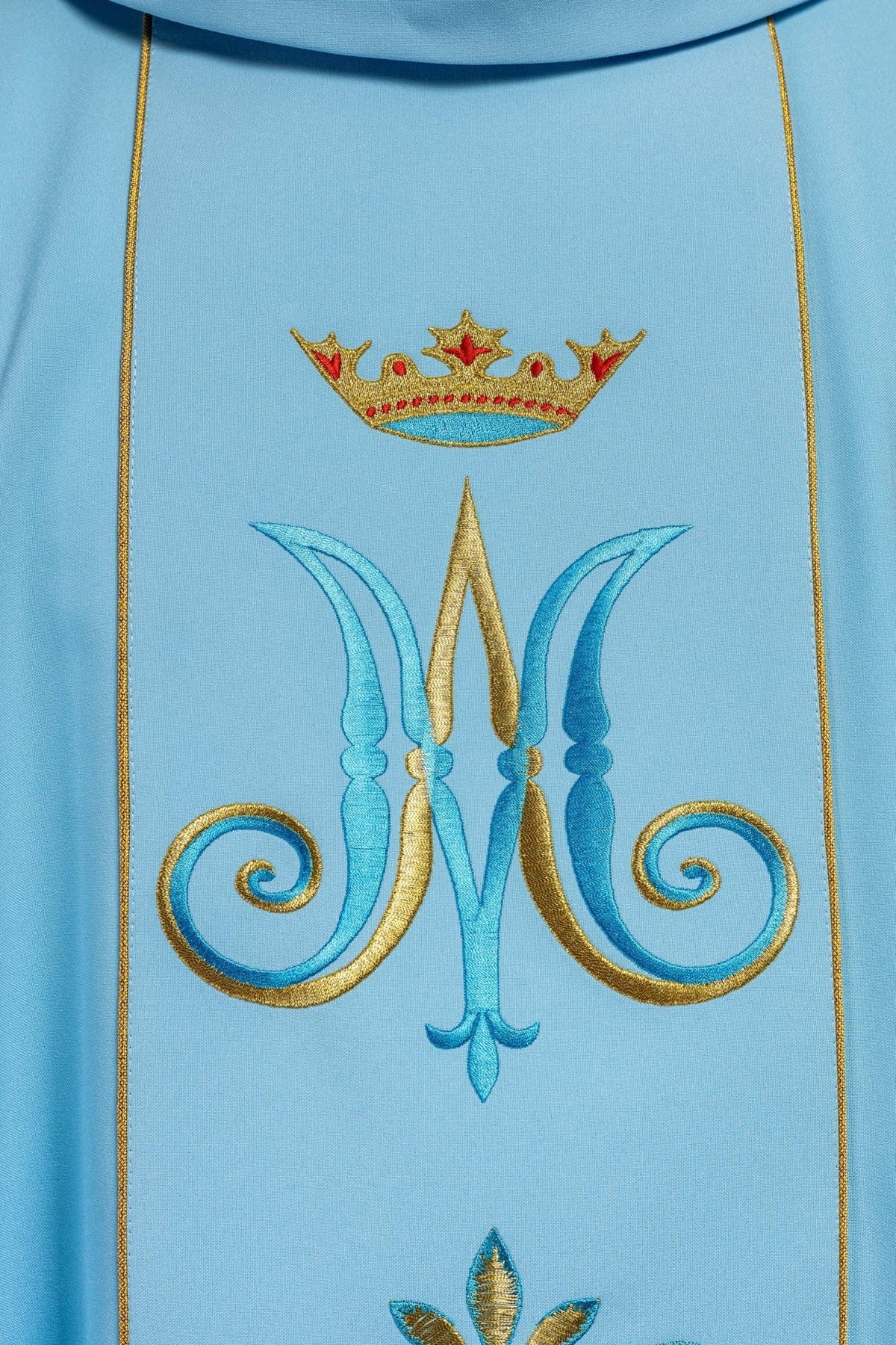Blue Marian chasuble, close-up of crown and Marian symbol embroidery