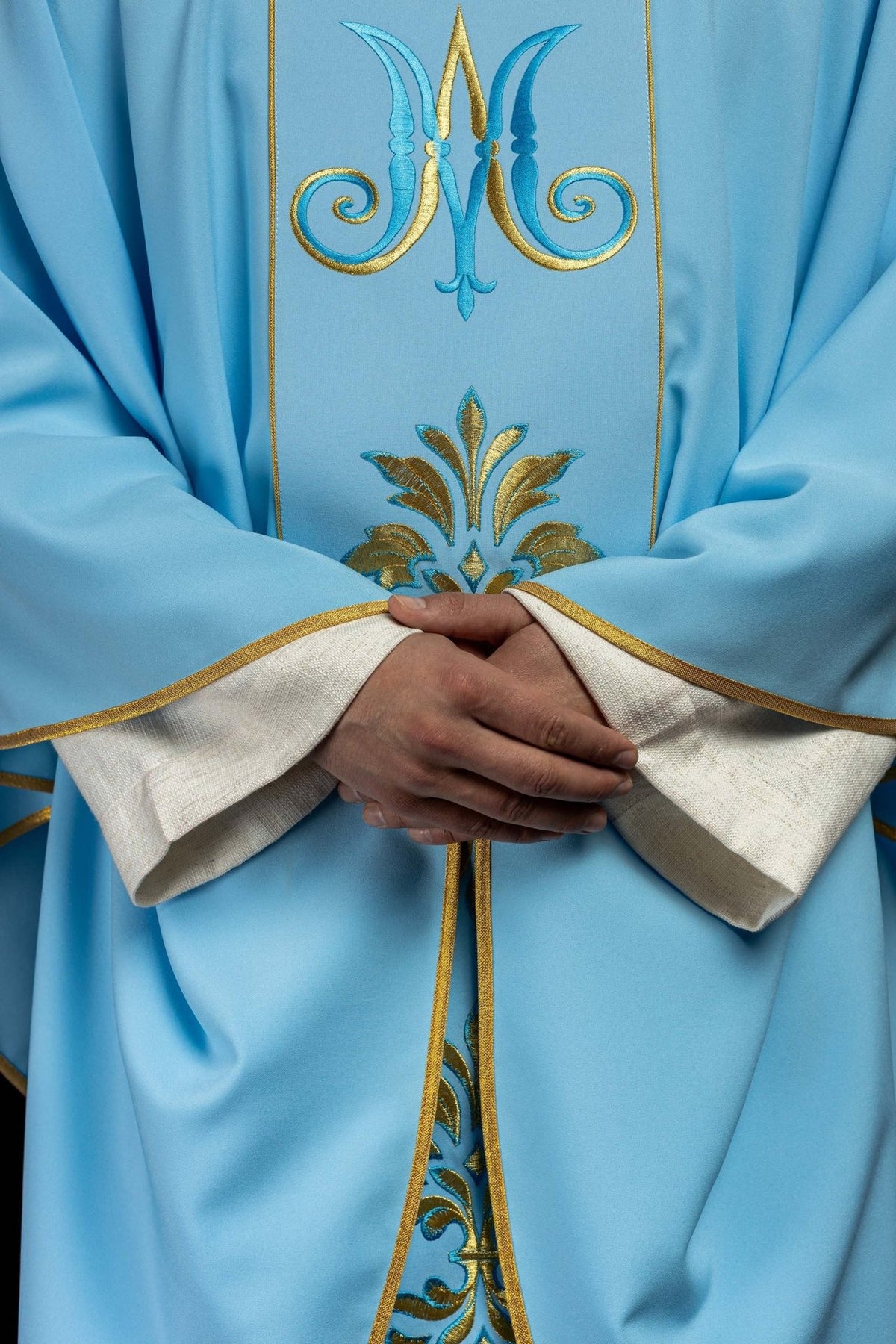Blue Marian chasuble, front detail with Marian symbol, floral embroidery and gold trim