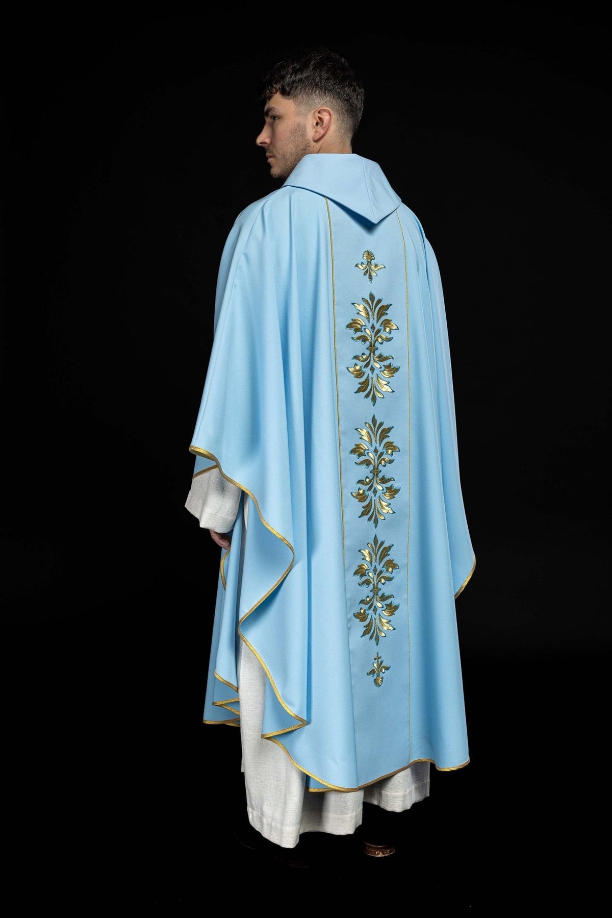 Blue Marian chasuble, rear three-quarter view with floral embroidery