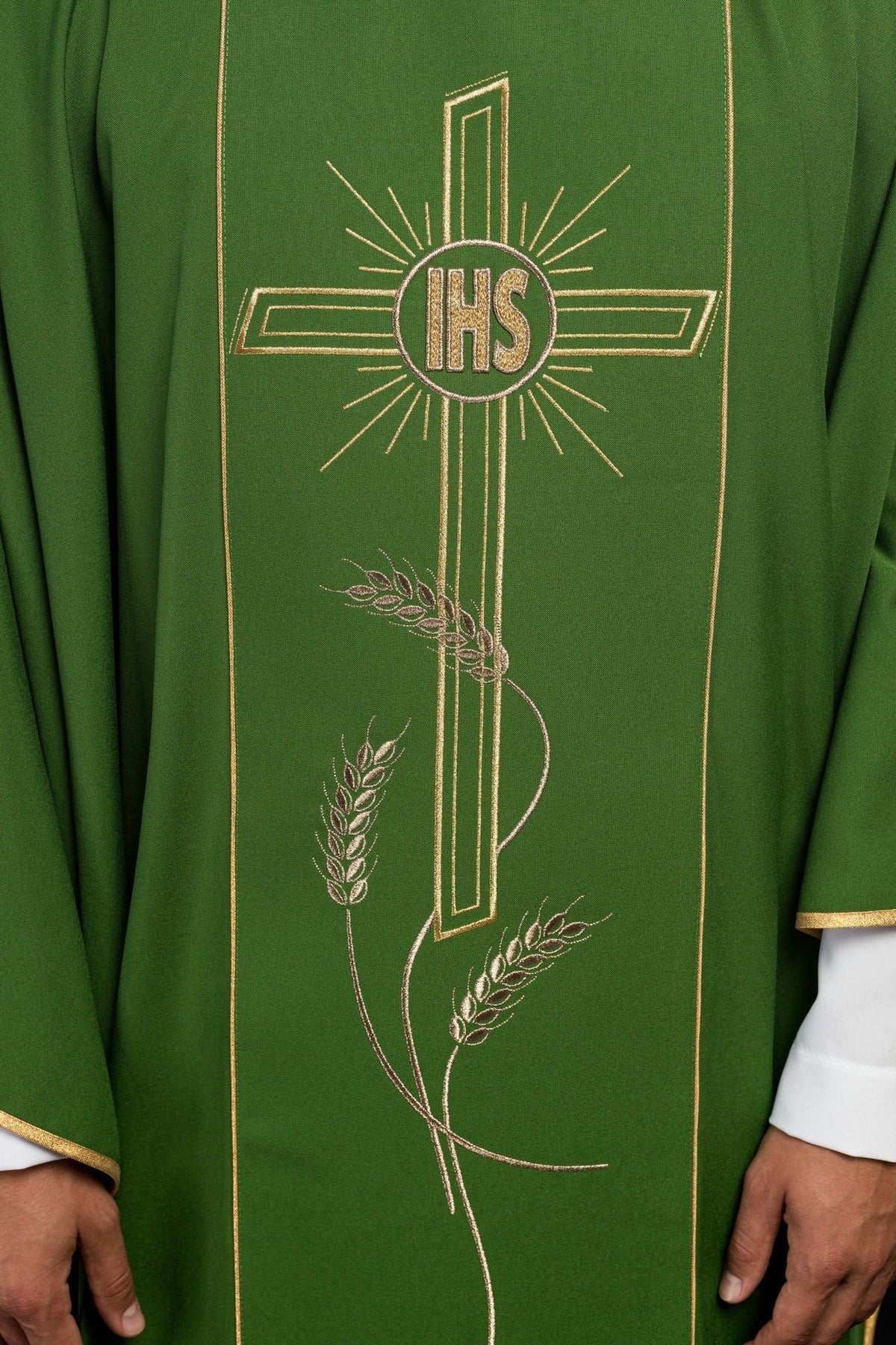 Green chasuble close-up of embroidered gold IHS cross and wheat motifs