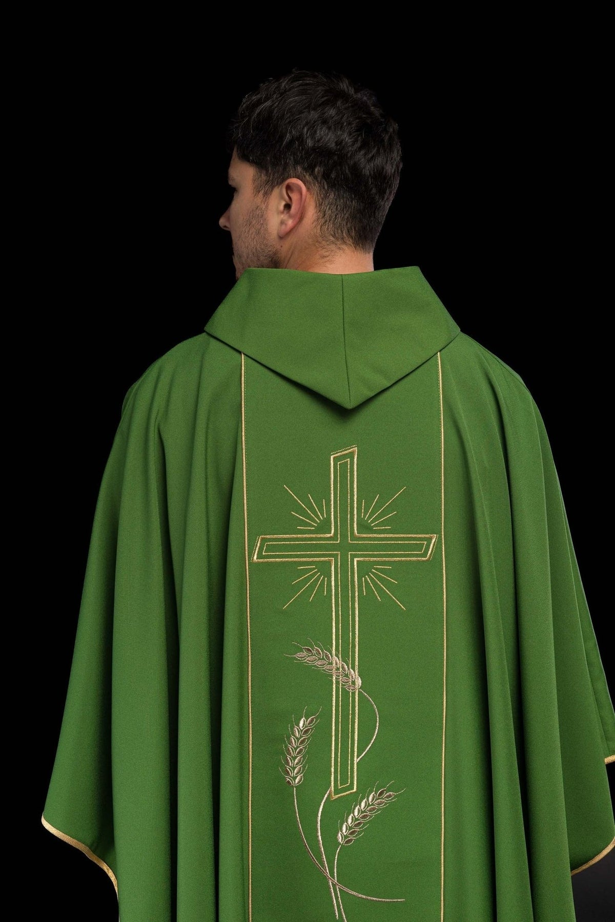 Green chasuble back close-up with gold cross and wide orphrey
