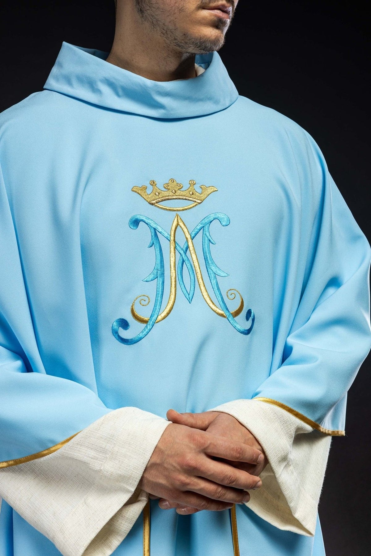 Blue chasuble close-up with embroidered Marian motif and stand-up collar