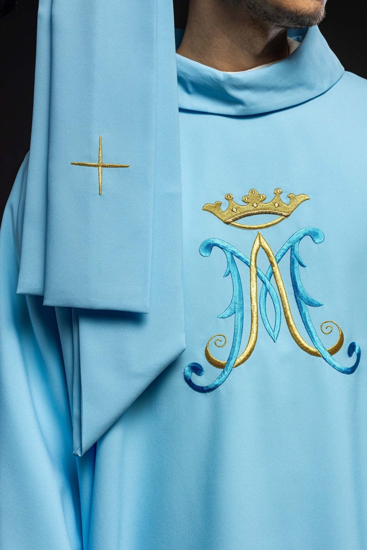 Blue chasuble front detail with Marian motif, gold trim and white sleeves