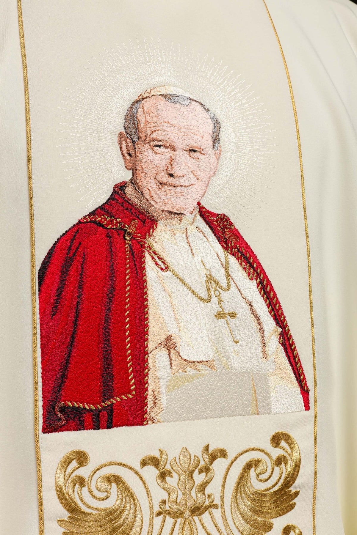 Chasuble close-up showing embroidered Pope John Paul II portrait in red and white