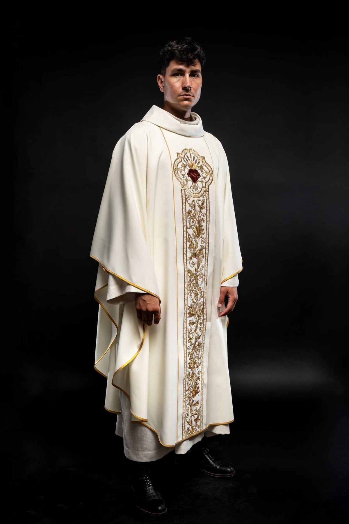 Ecru chasuble worn, full front view with gold Sacred Heart of Jesus embroidery and trim