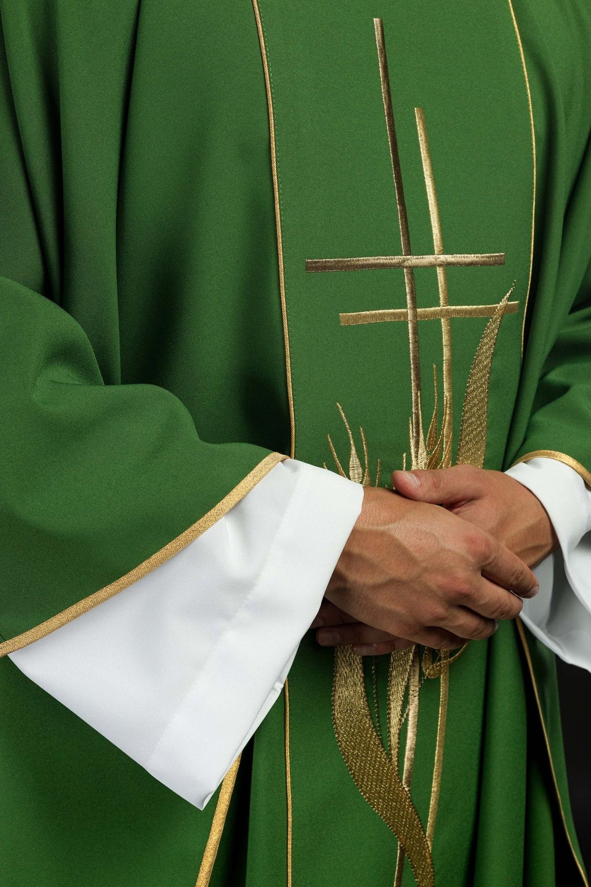 Green chasuble close-up showing gold trim, cross and wheat embroidery