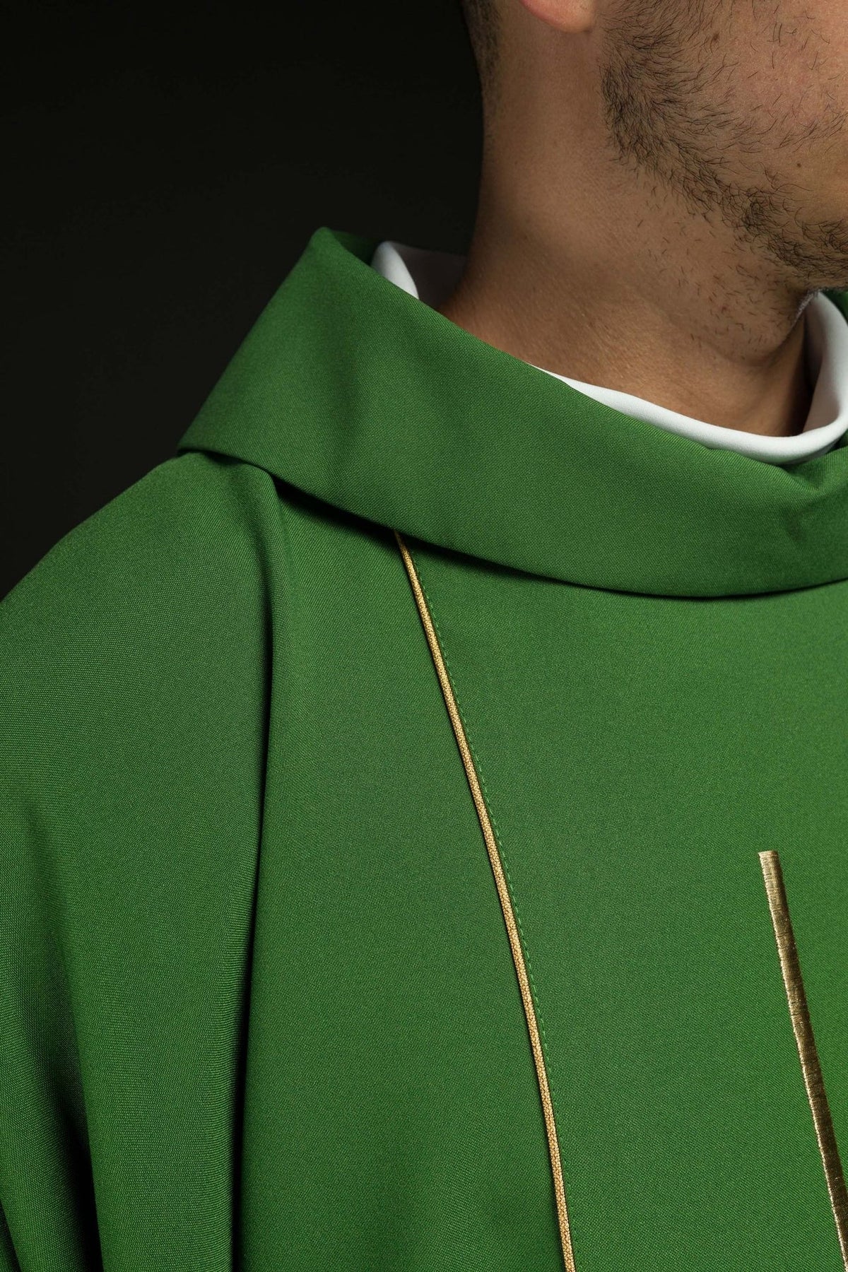 Green chasuble close-up showing stand-up collar and gold trim