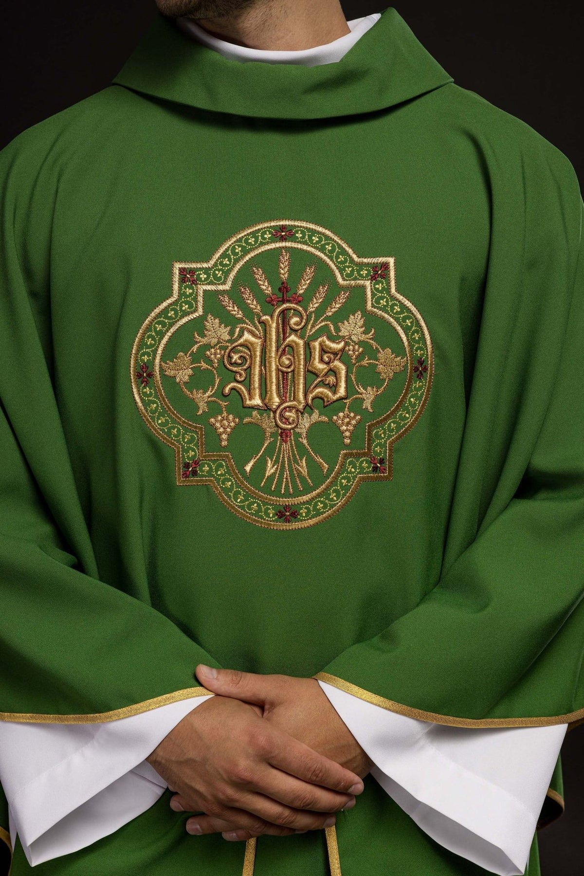 Green chasuble close-up showing stand-up collar and front IHS embroidery