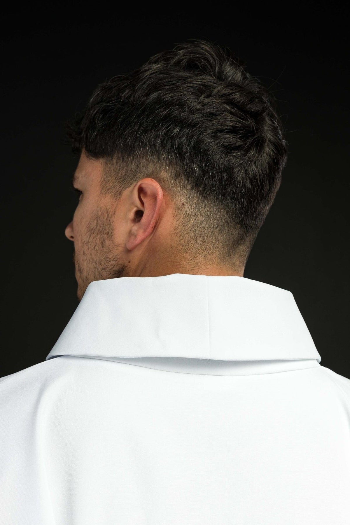 White Marian chasuble back view with embroidered Marian monogram, crown and gold trim