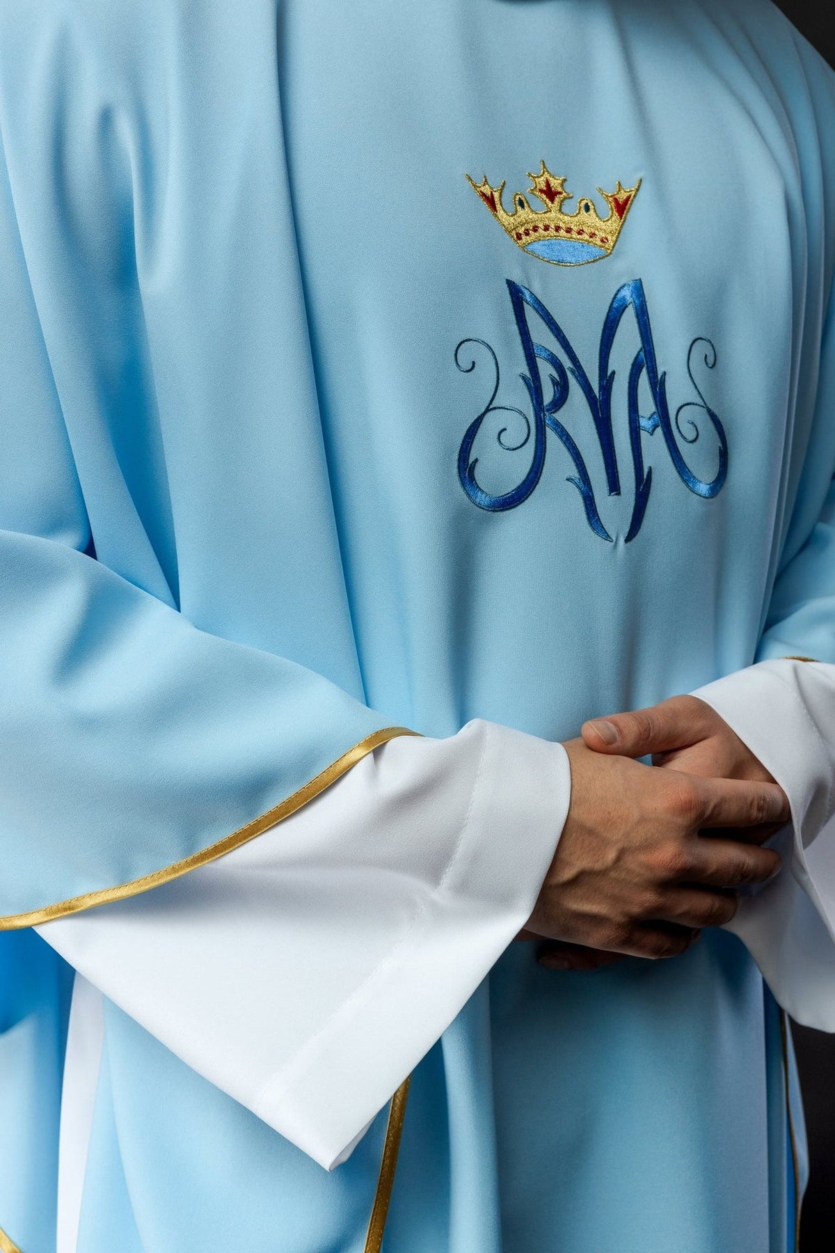 Blue Marian chasuble close-up showing Marian symbol embroidery and gold trim