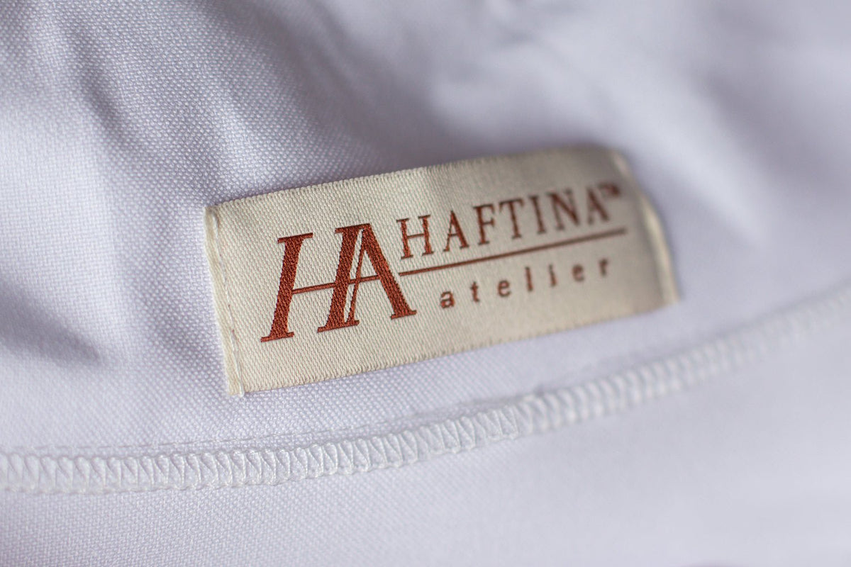 Manufacturer label and stitching detail belonging to the White Marian Chasuble with Orphrey