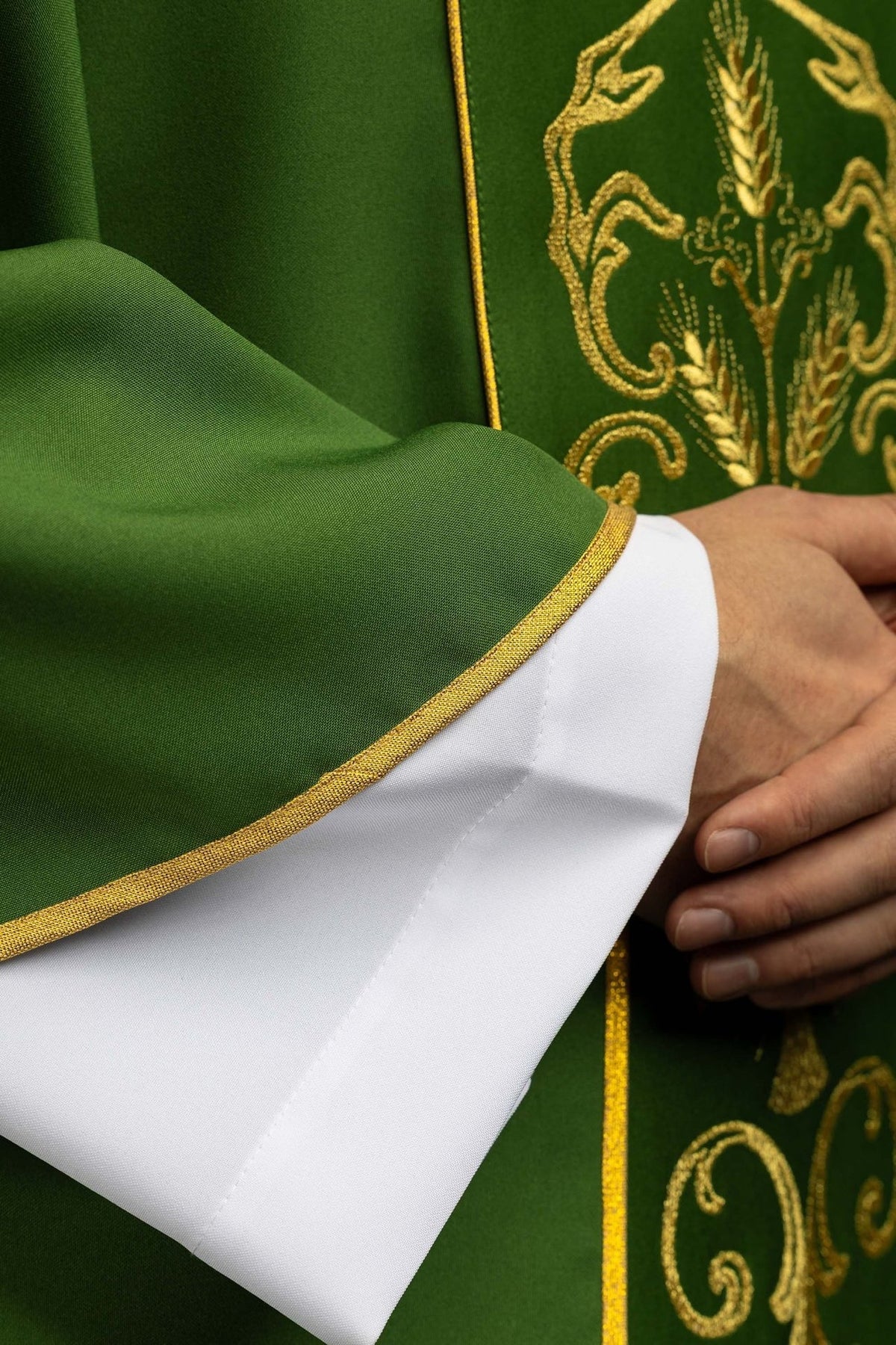 Green chasuble, close-up of gold trim on the sleeve and embroidered orphrey
