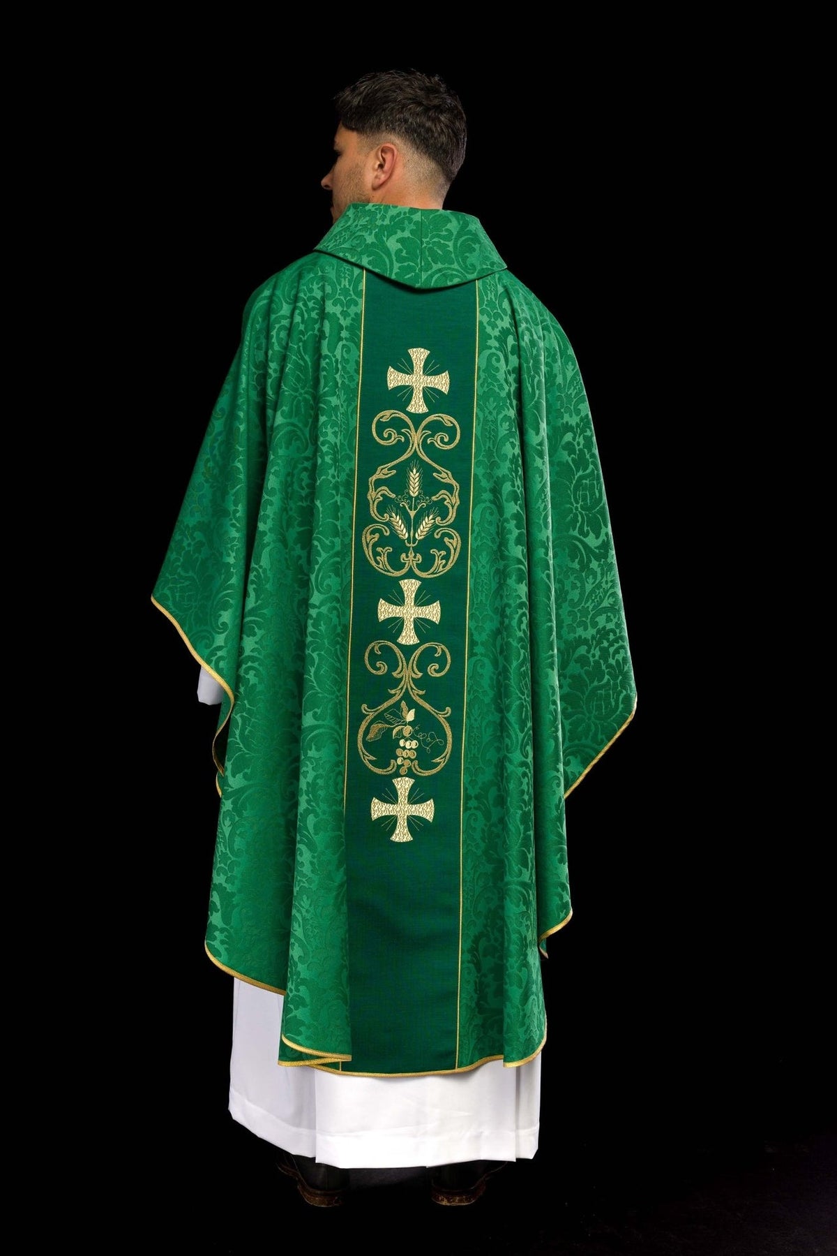 Green chasuble back view with embroidered orphrey and gold cross motifs