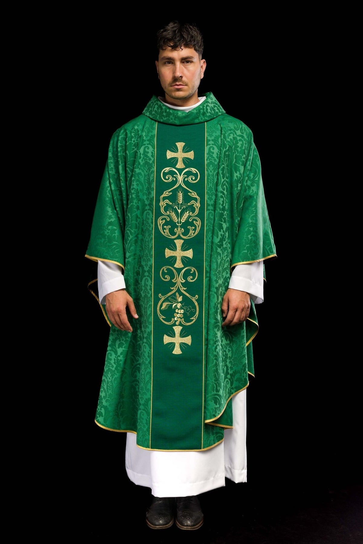 Green chasuble worn from the front, showing the stand-up collar and patterned sleeves