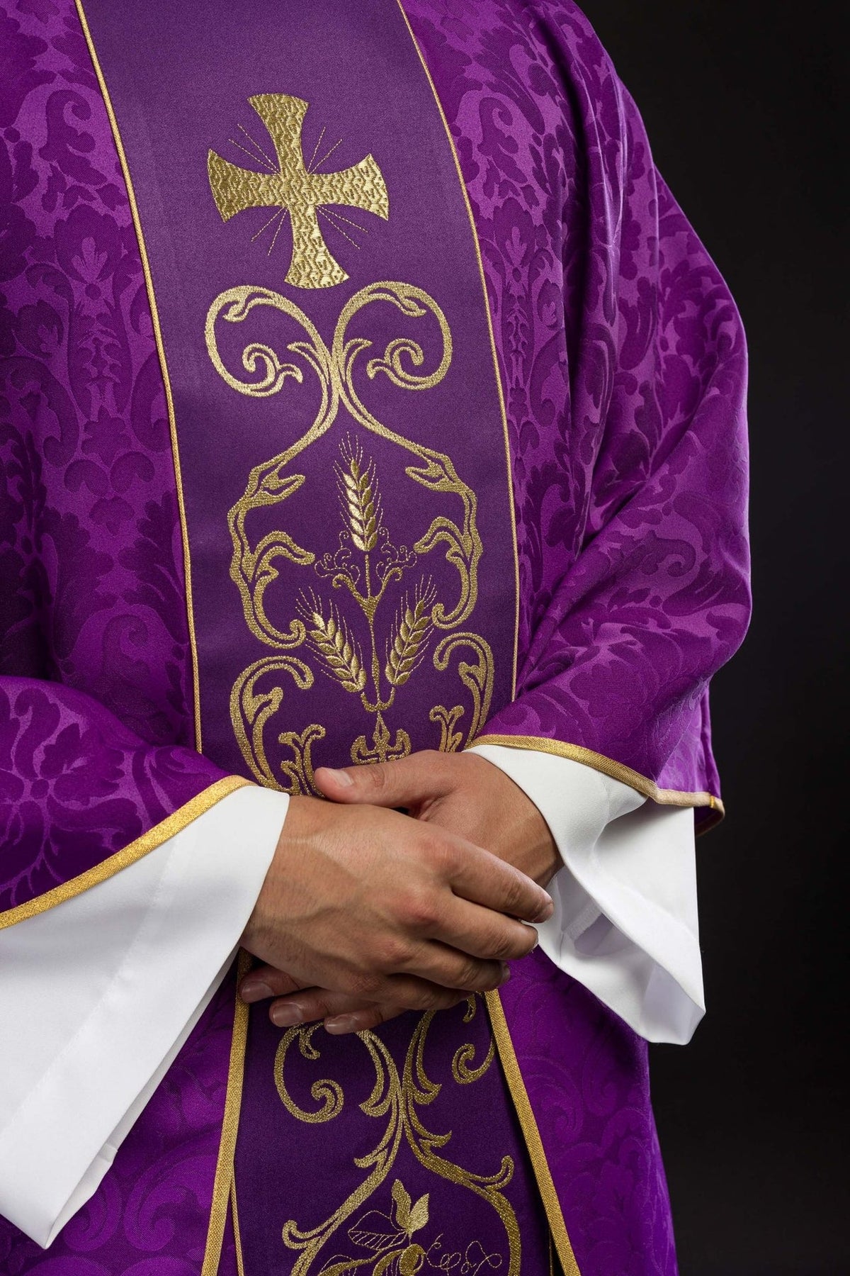 Purple chasuble close-up showing embroidered gold orphrey and gold trim