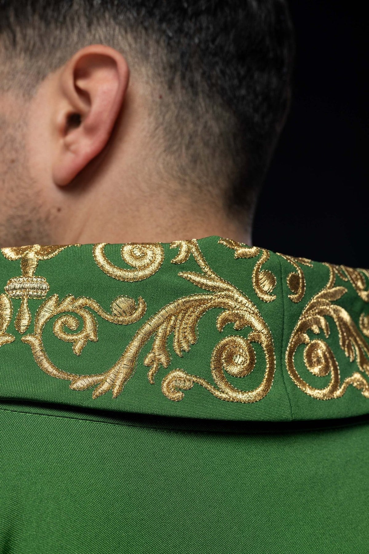 Green chasuble detail showing gold embroidered stand-up collar