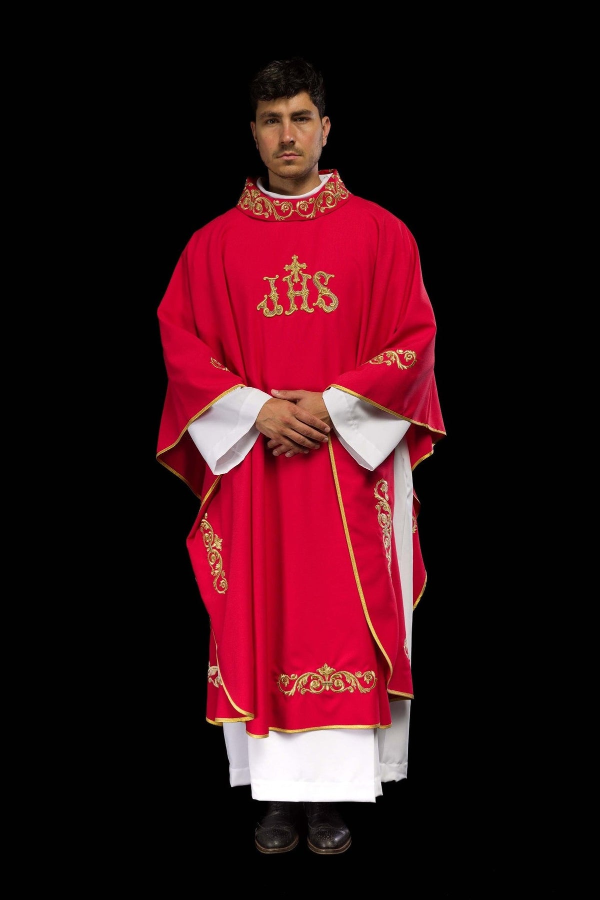 Red chasuble front view showing gold IHS embroidery, sleeve motifs and trim