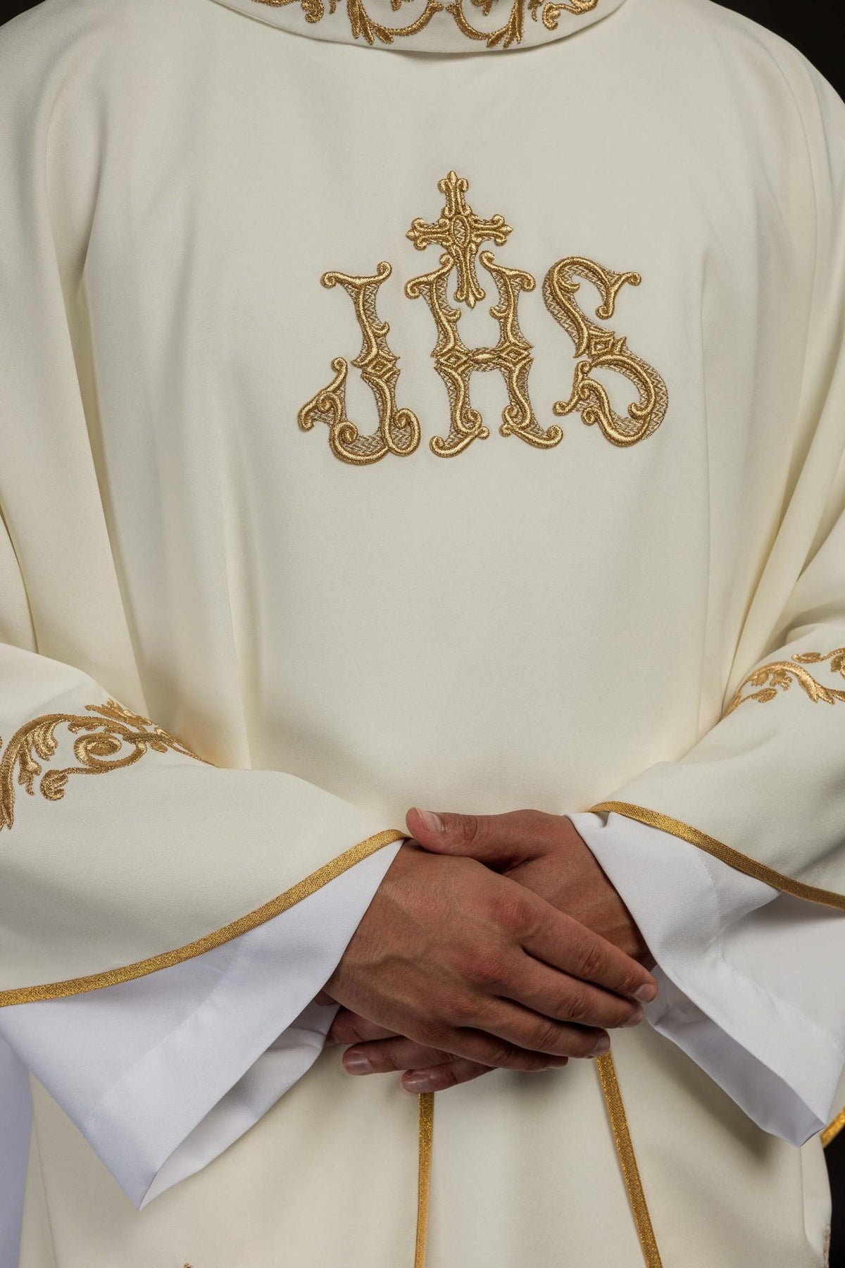 Ivory chasuble front detail with gold IHS embroidery and gold-edged sleeves