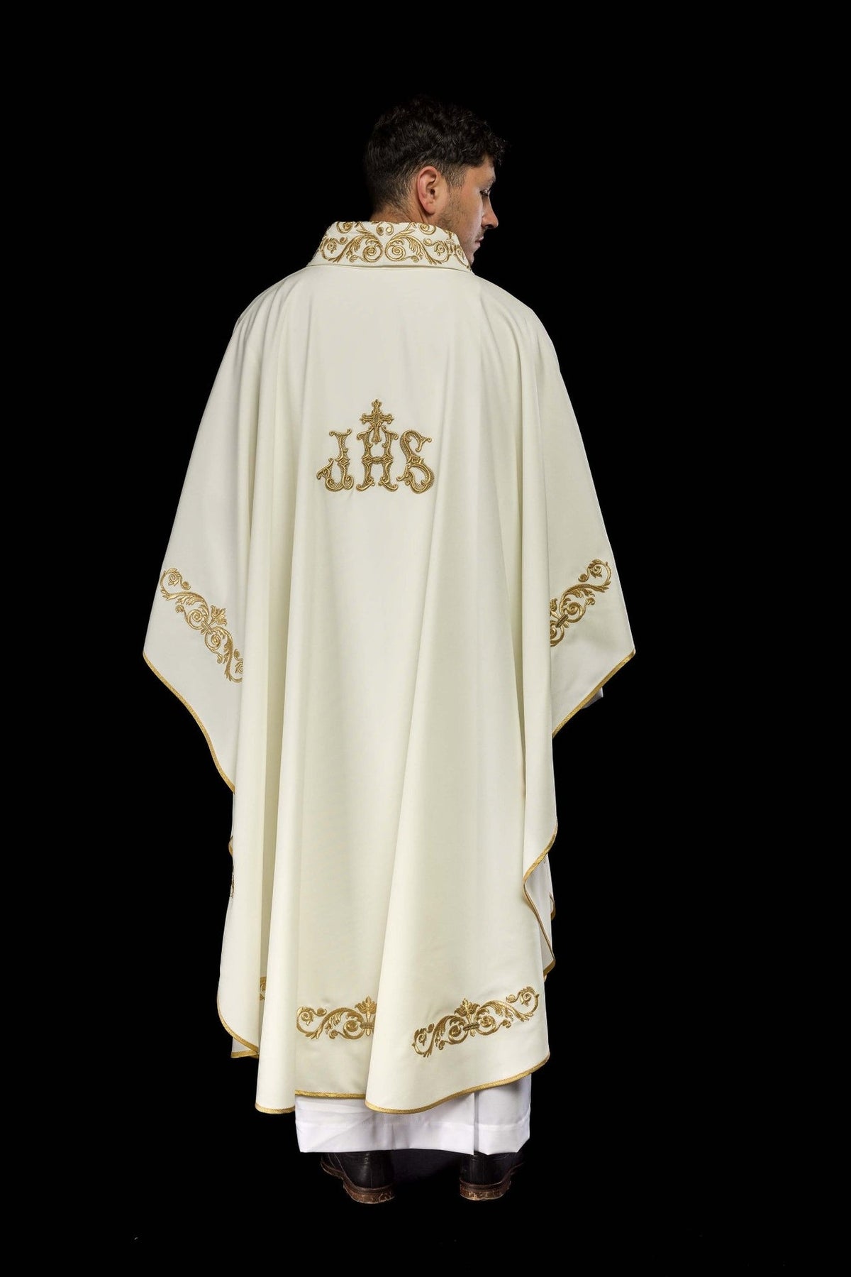 Ivory chasuble back view showing gold IHS embroidery and ornate trim