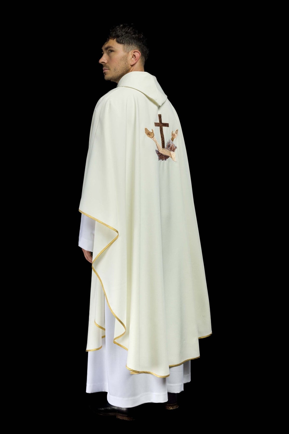 White chasuble side view showing the back embroidery and gold trim