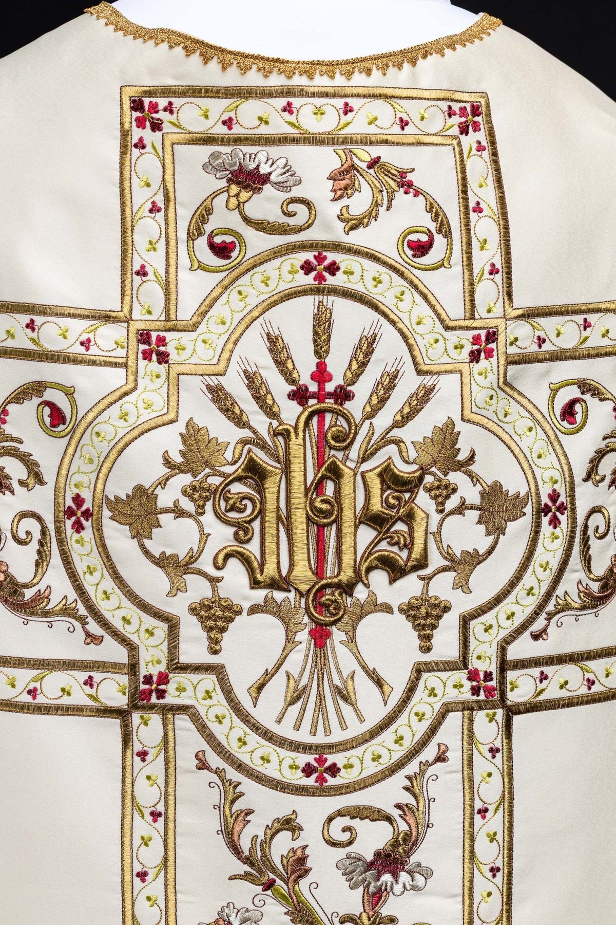 Roman chasuble close-up of embroidered IHS motif with gold thread and floral details