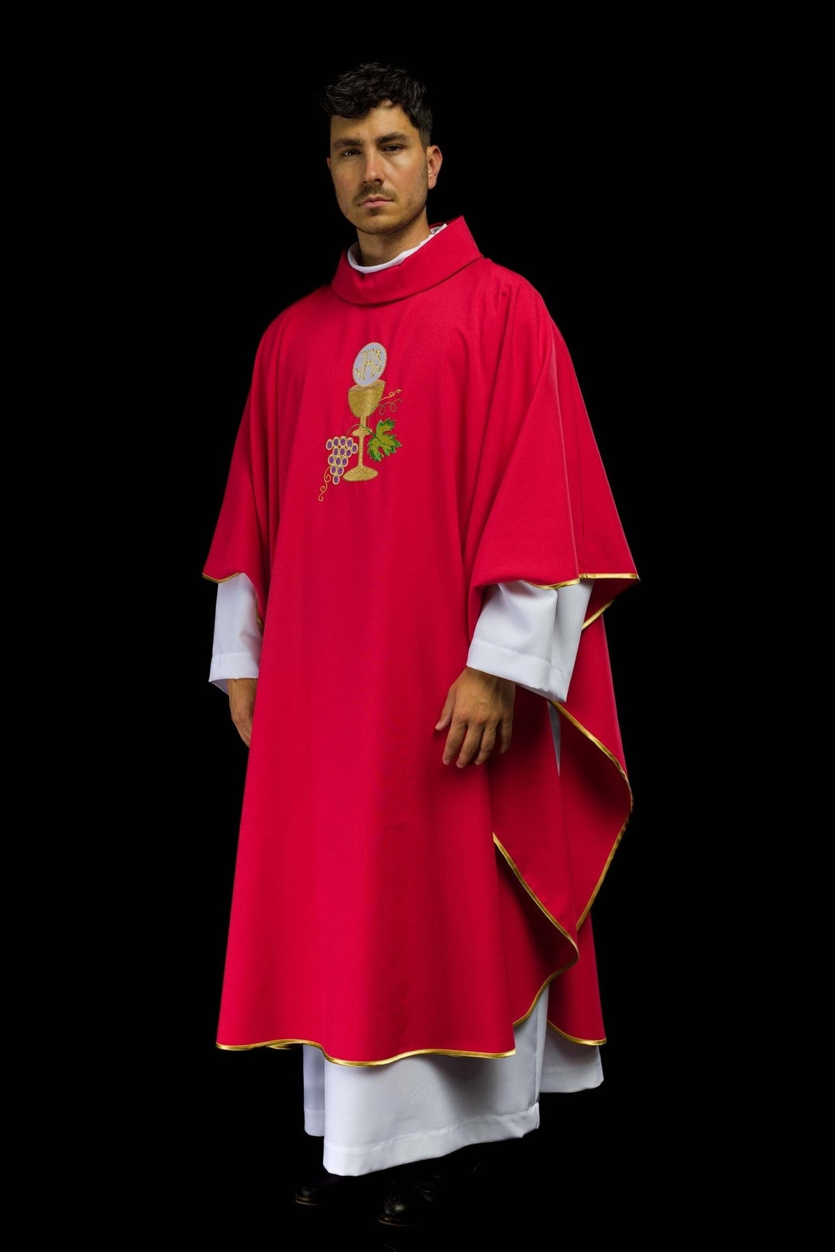 Red chasuble, side view showing flowing satin fabric and gold trim