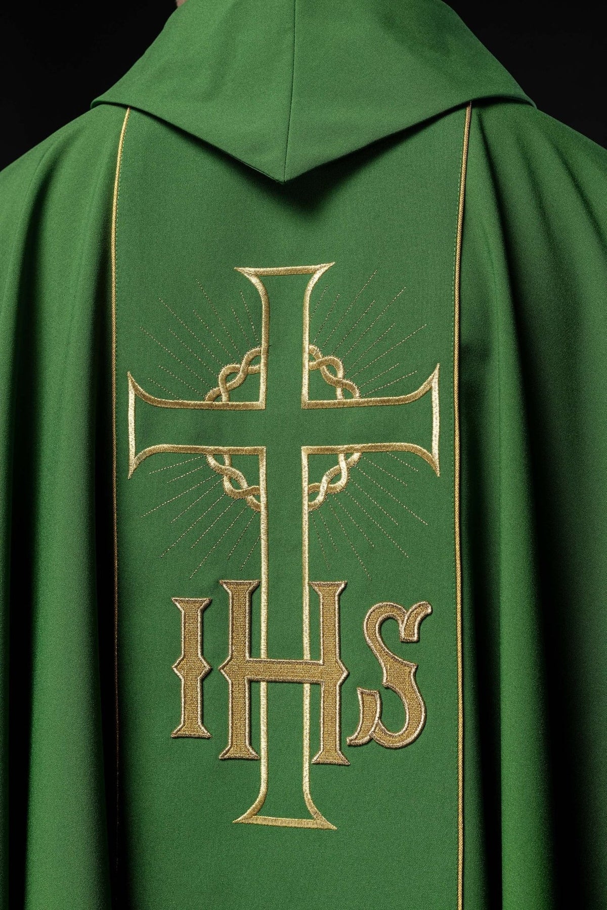 Green chasuble back close-up showing gold cross and IHS embroidery