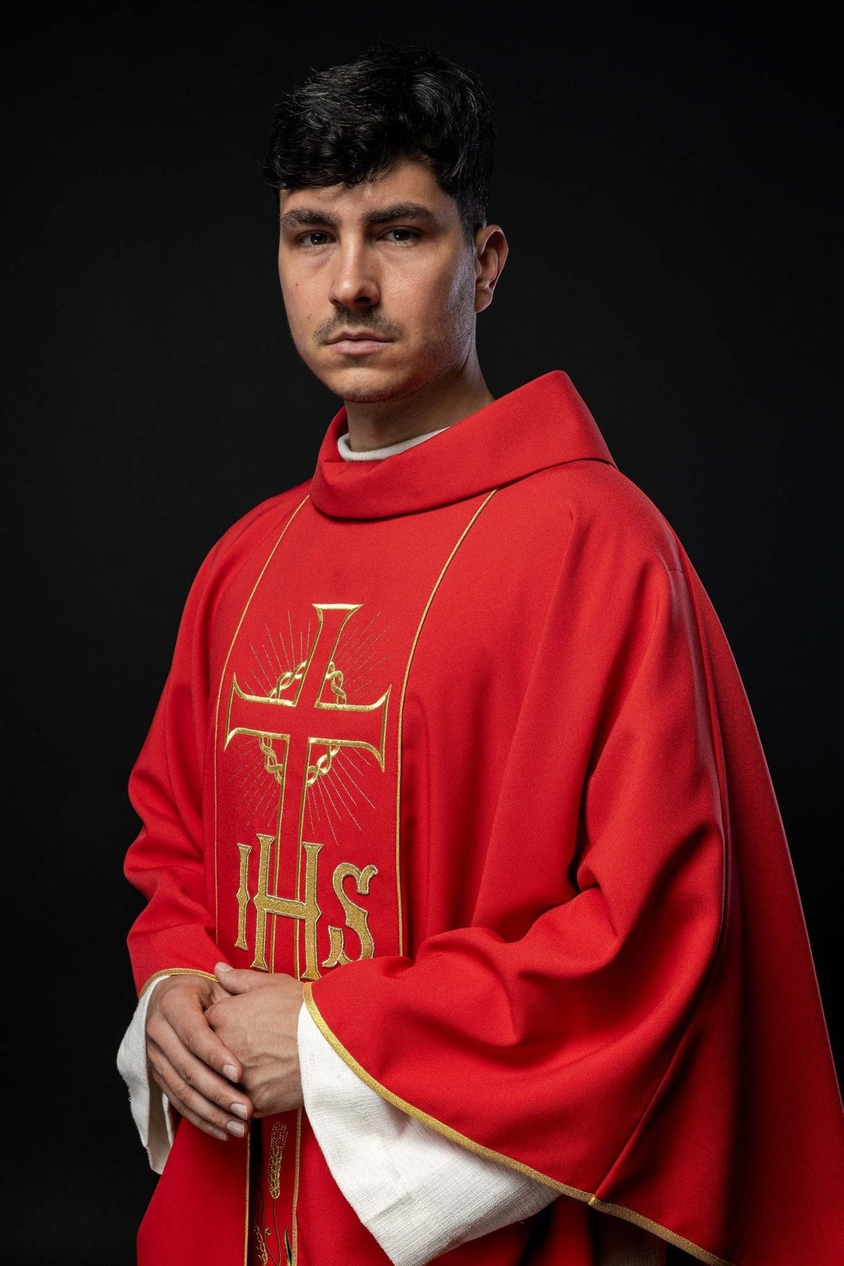 Red chasuble, front three-quarter view showing gold cross, IHS and trim