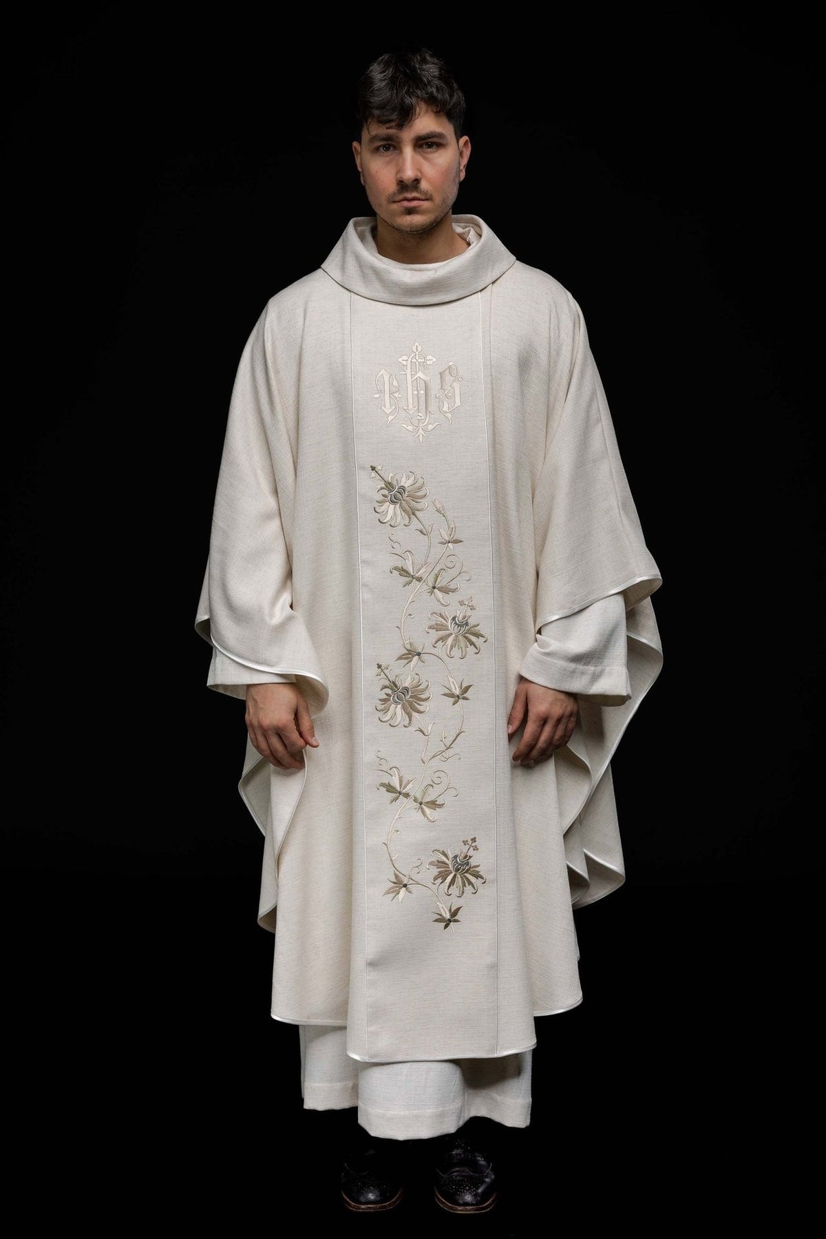 Ecru chasuble front view with embroidered IHS orphrey and floral motifs