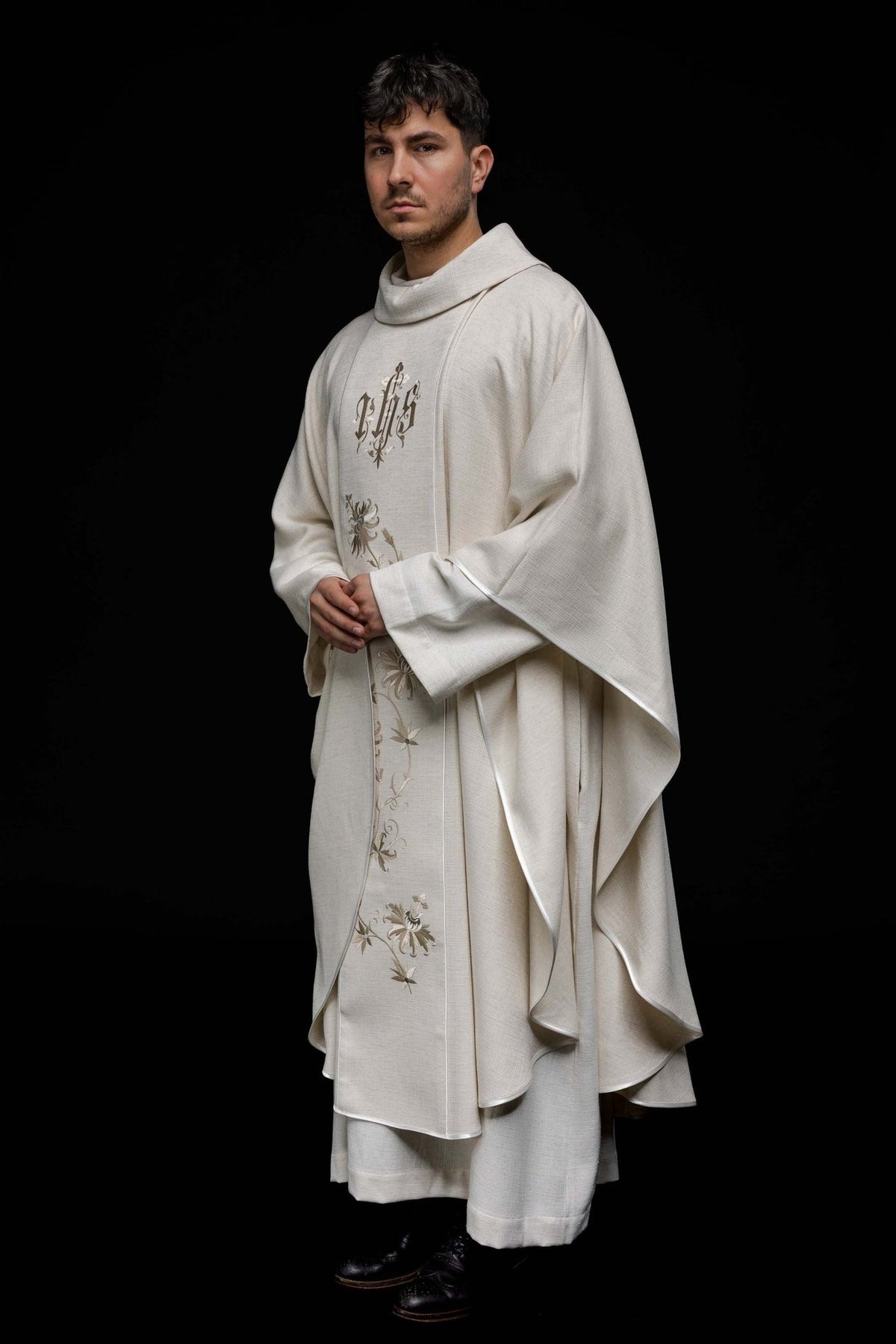 Ecru chasuble side view showing flowing cut, embroidered orphrey and white trim