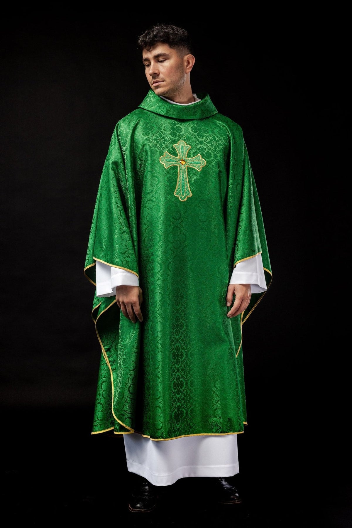 Green embroidered chasuble, full front view with gold cross and patterned fabric