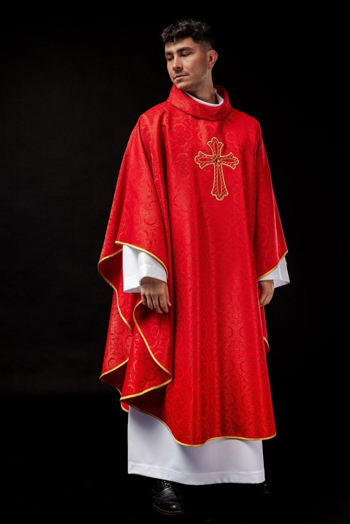 Red chasuble worn, full front view with gold trim and embroidered cross
