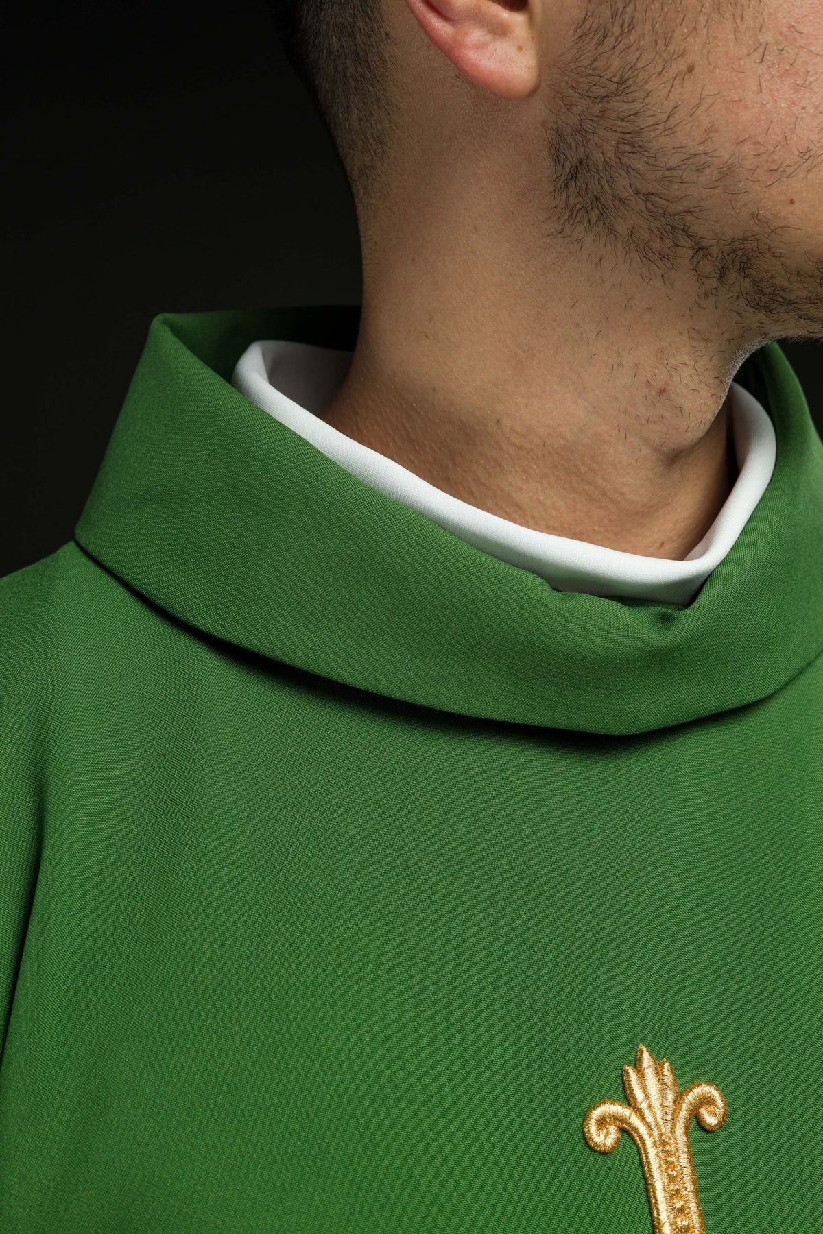 Green chasuble close-up showing the stand-up collar and raised gold embroidery