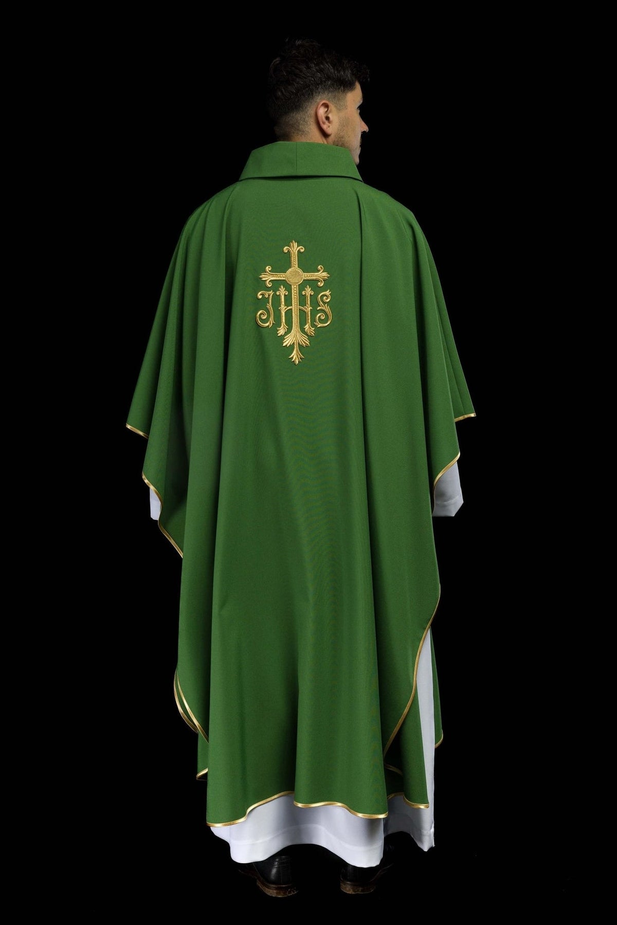 Green chasuble worn from the back, with gold JHS embroidery and trim