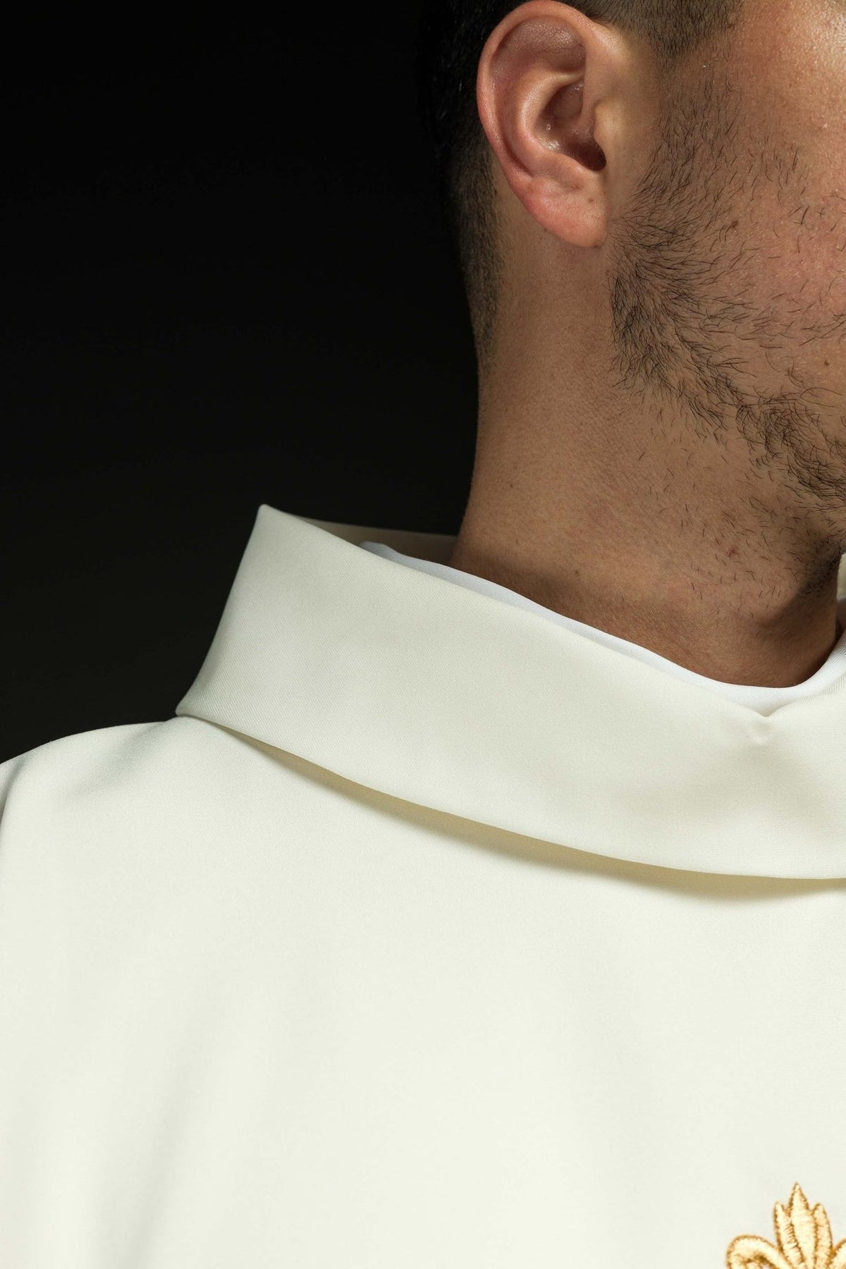 Chasuble close-up showing ecru stand-up collar and gold trim