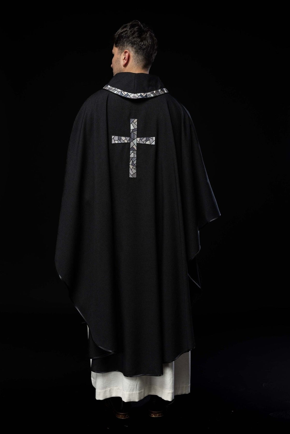 Black chasuble back view with mosaic cross and collar trim