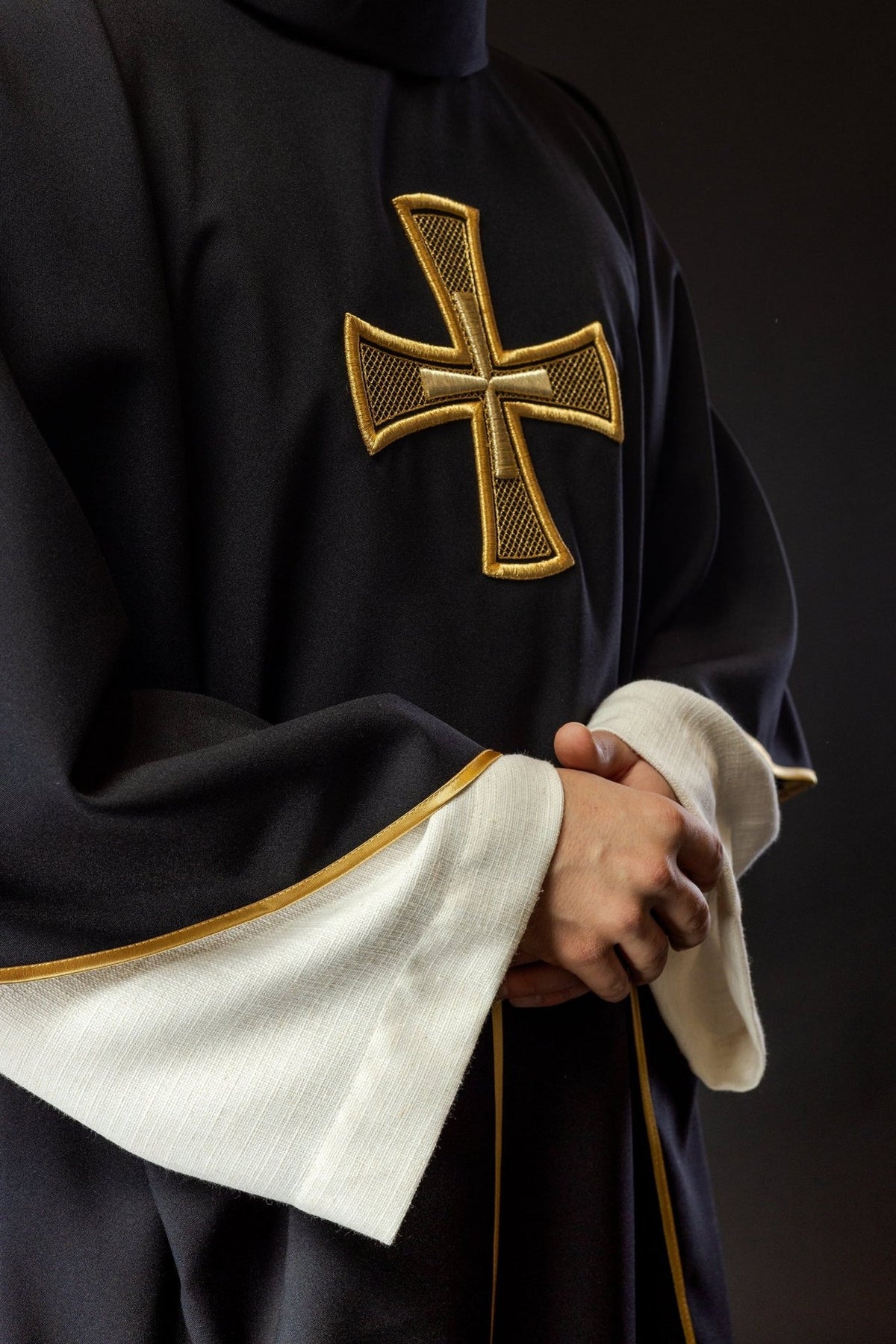 Black chasuble side view with gold cross embroidery and gold trim