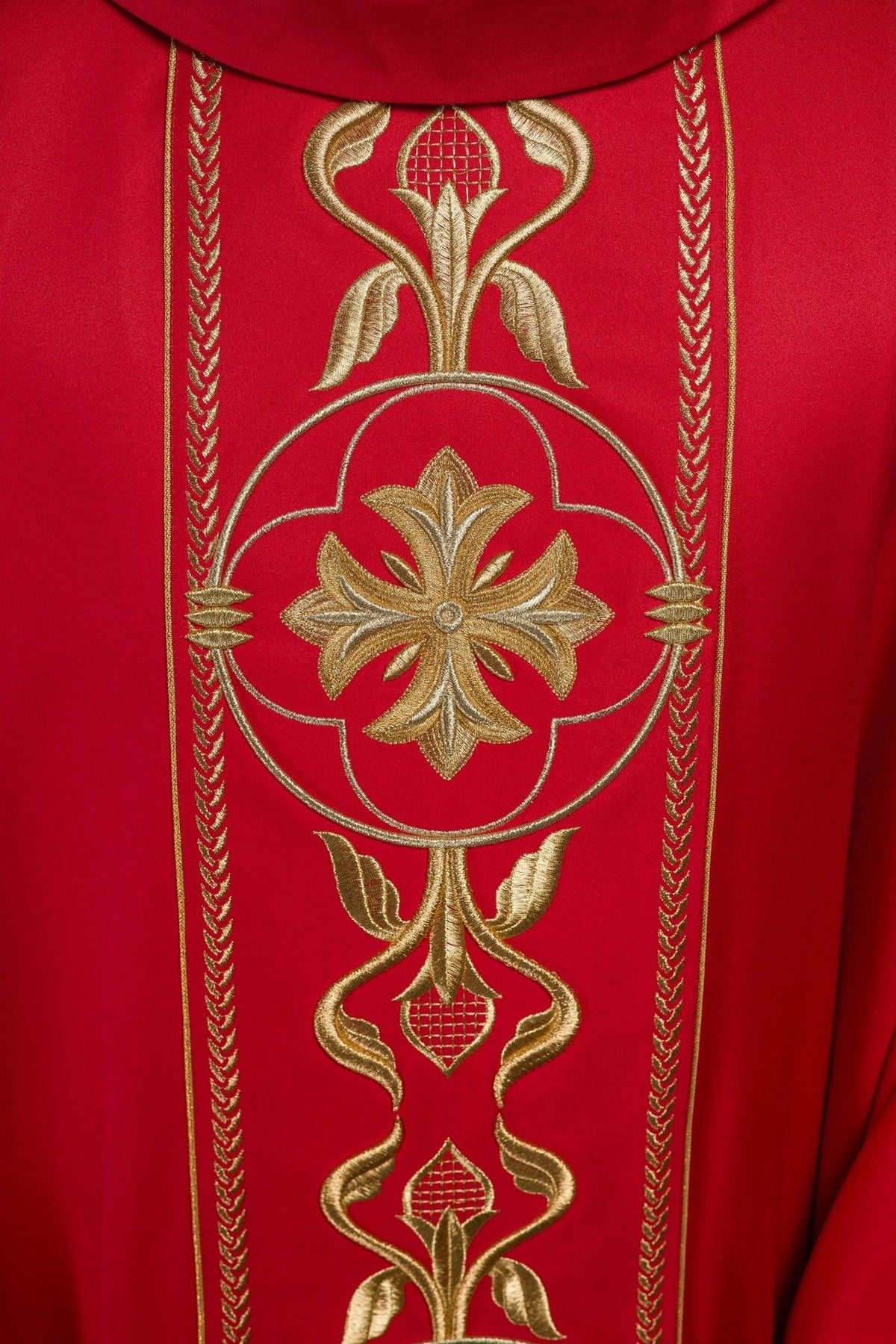 Red chasuble orphrey close-up with gold floral embroidery