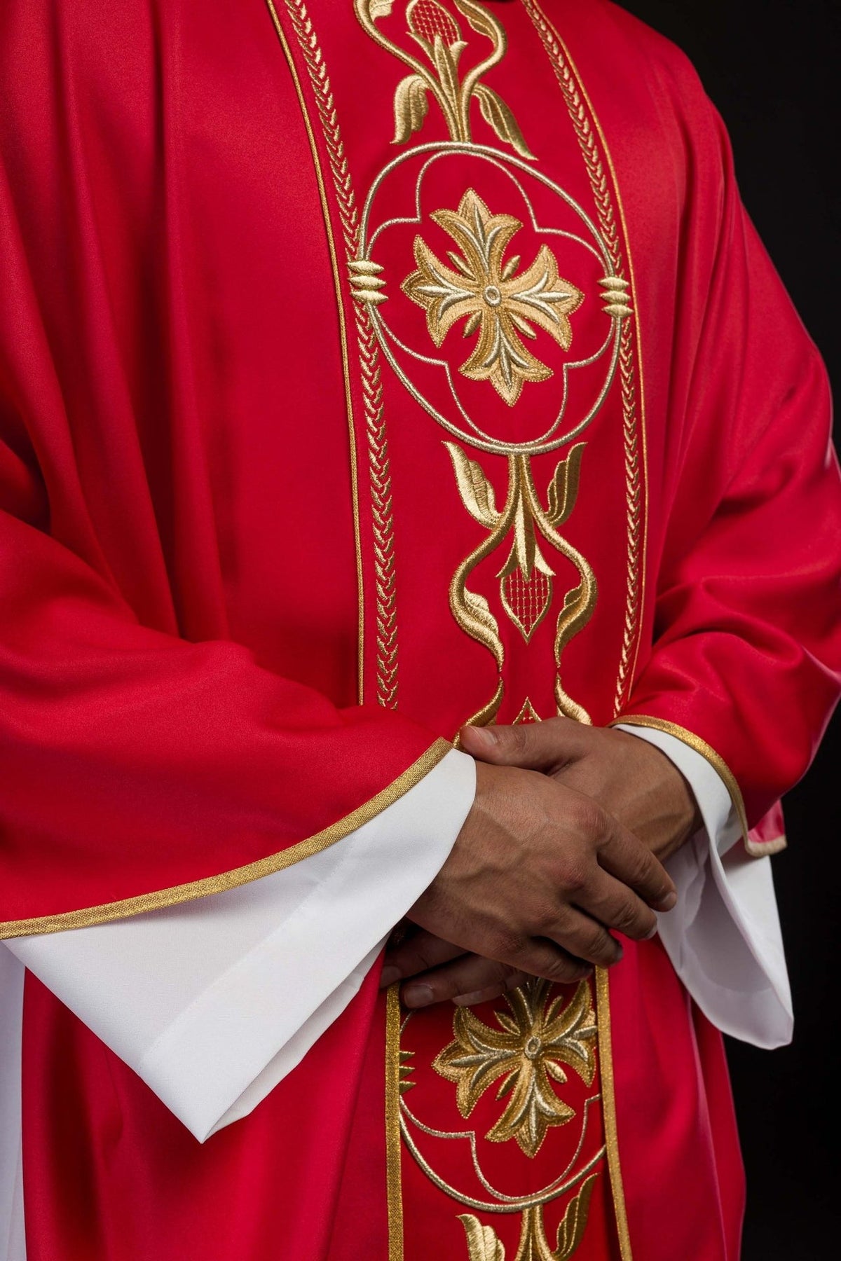 Red chasuble front detail showing gold floral embroidery and trim