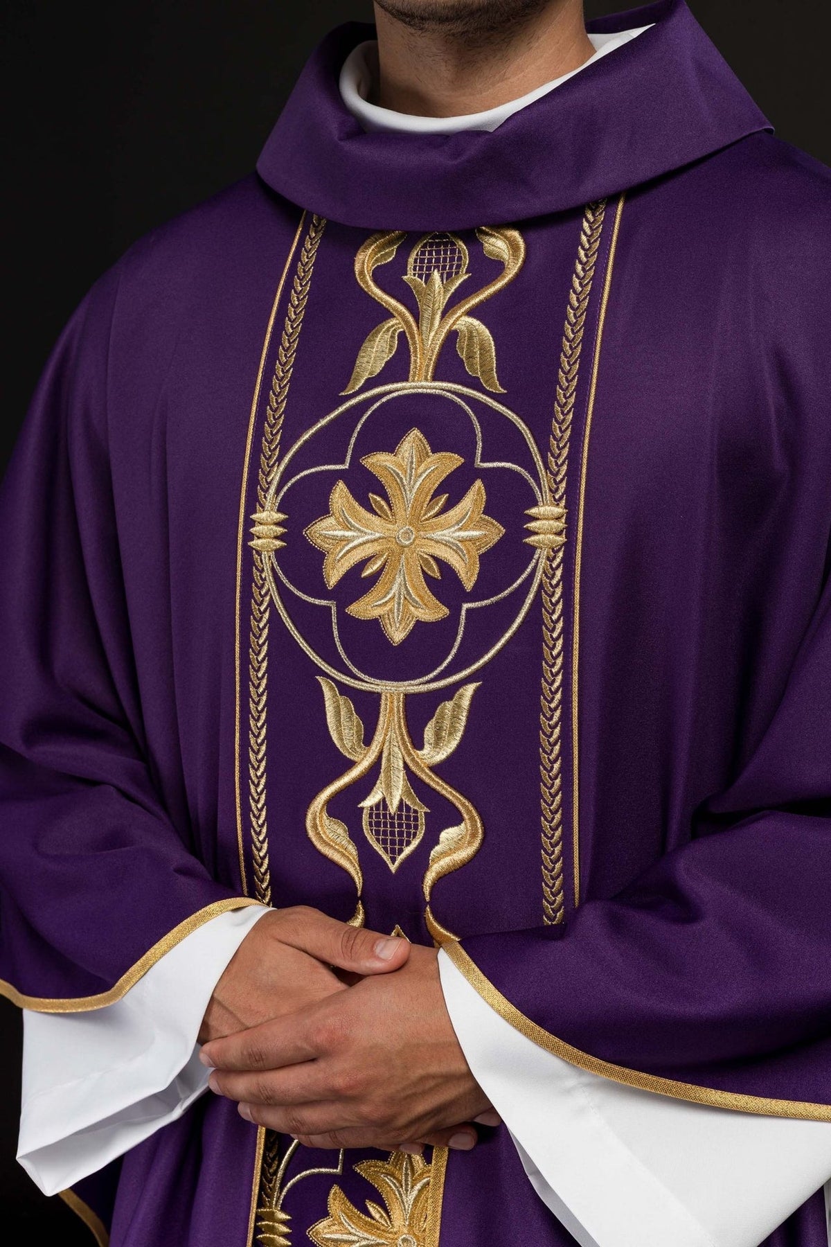Purple chasuble close-up showing gold floral embroidery on the front orphrey