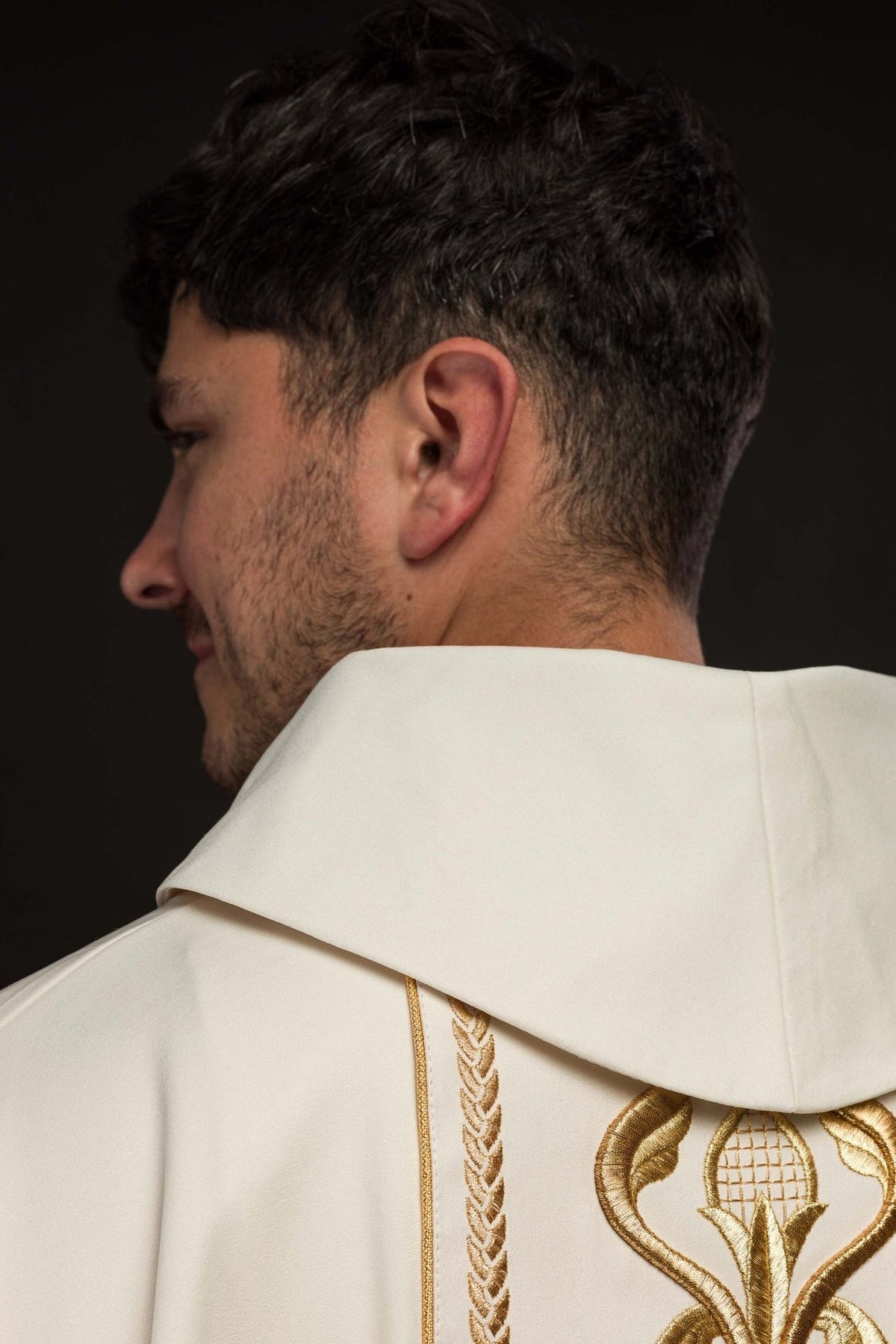 Ecru chasuble worn front view with gold embroidery and trim