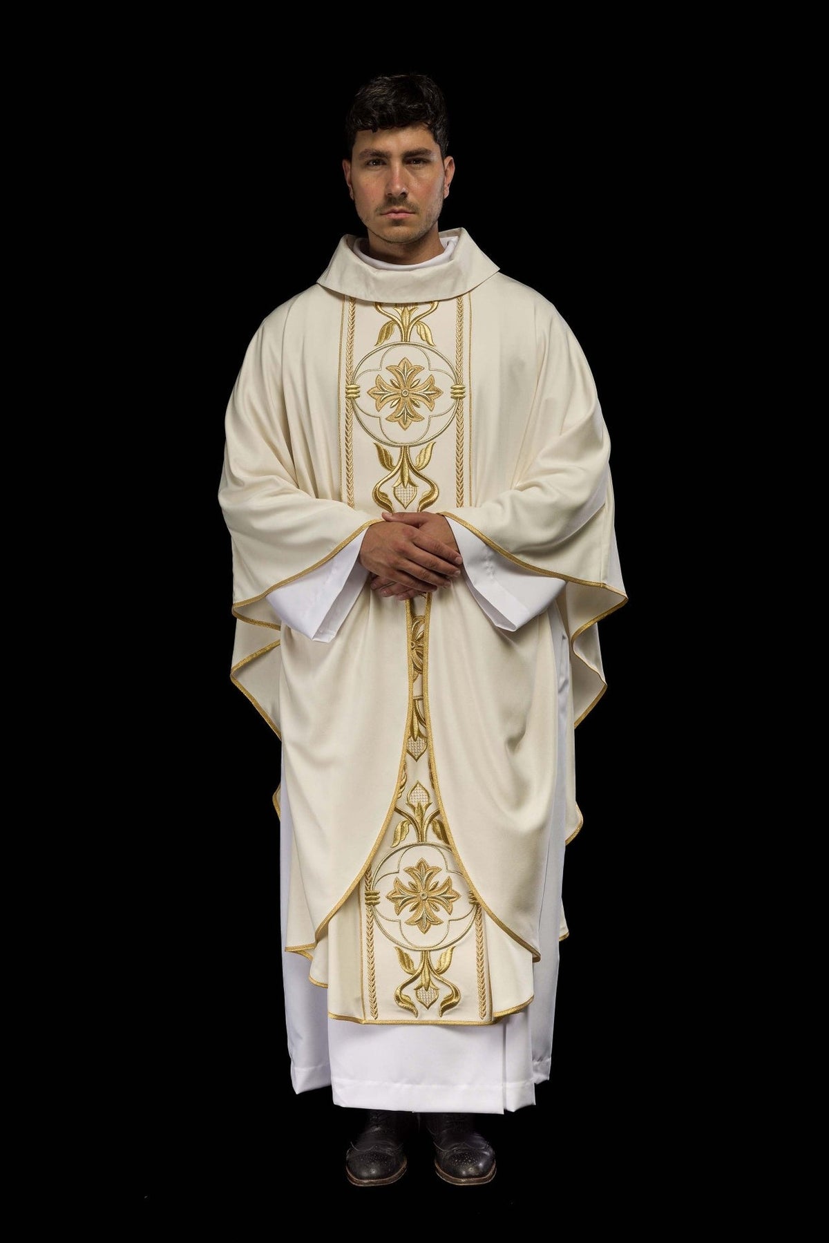 Ecru chasuble side back view showing flowing fabric and gold embroidered panel