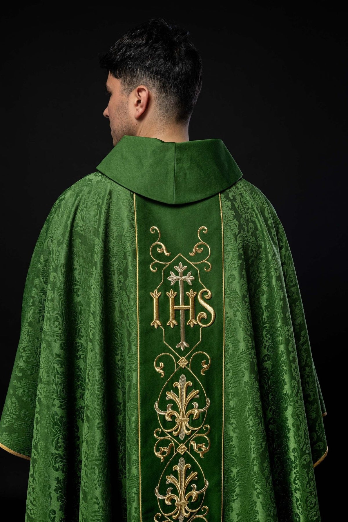Green chasuble detail showing floral-patterned fabric and stand-up collar